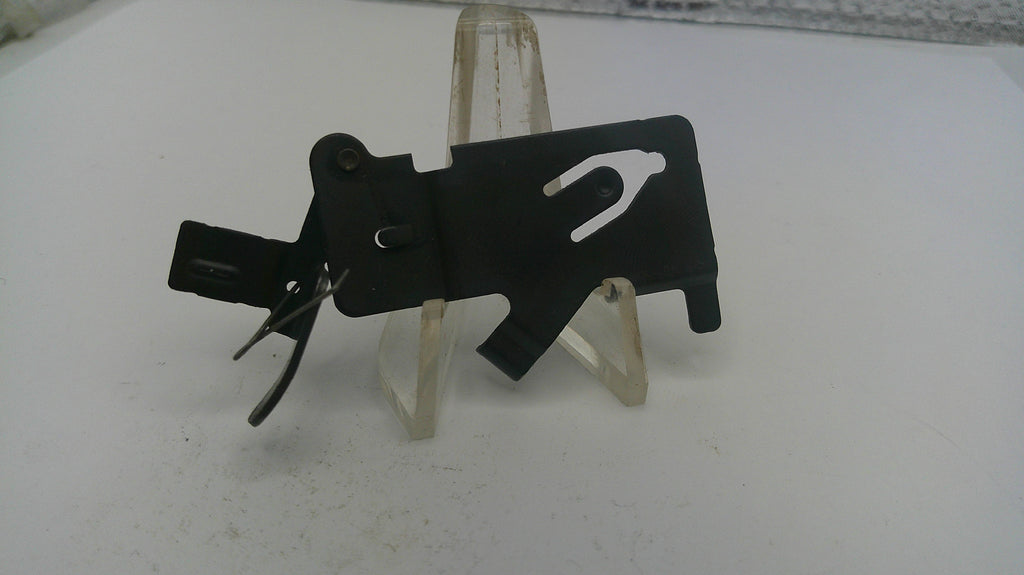 Black metal tool on a white stand with a white background