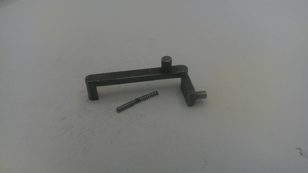 Metallic lever and screw on a white surface