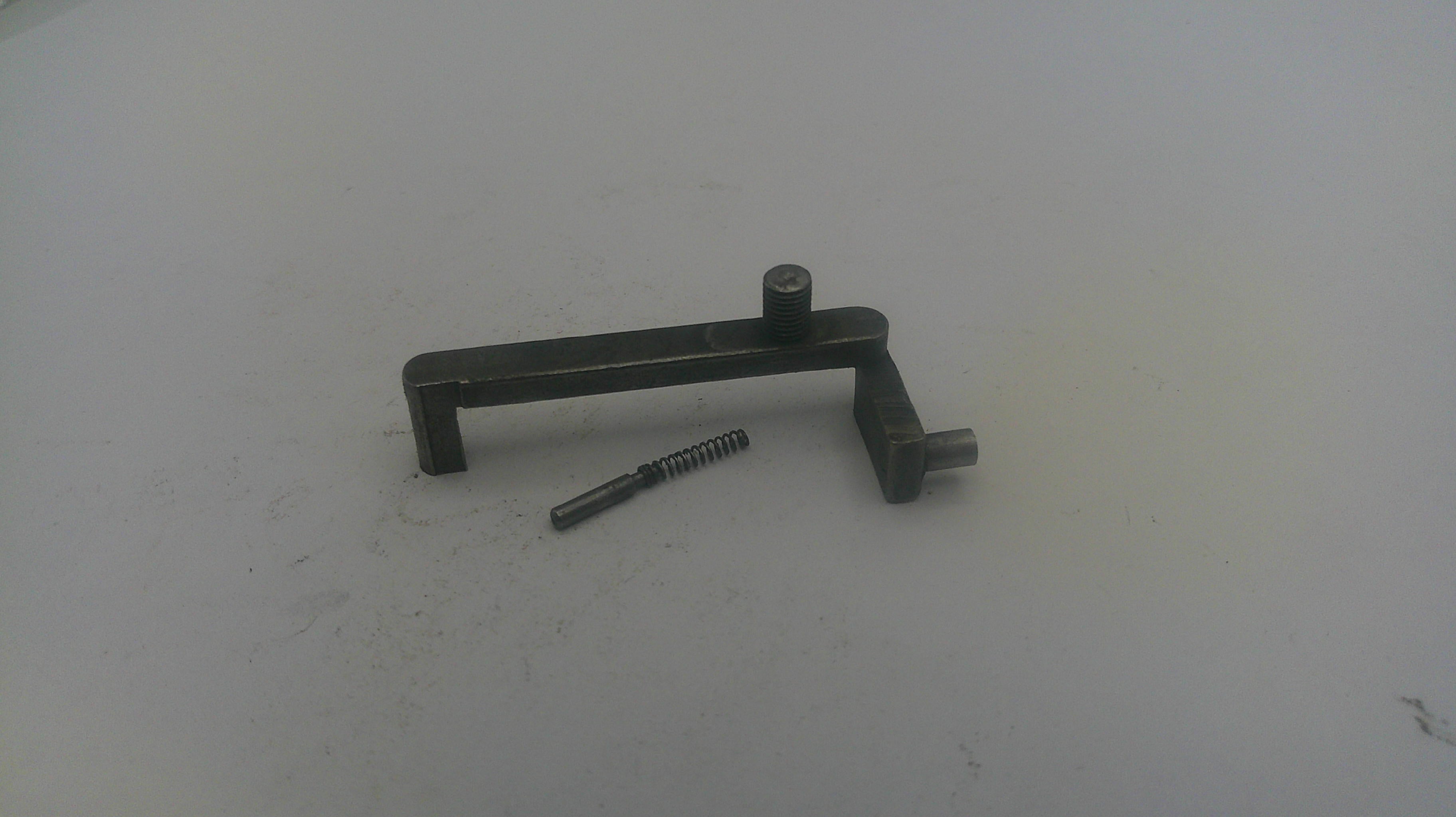 Metallic lever and screw on a white surface