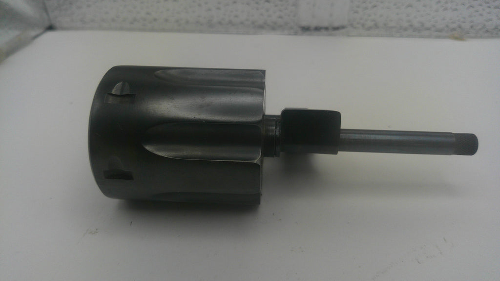 A dark gray metal rotary hammer drill bit with a long shank, photographed on a plain white surface.