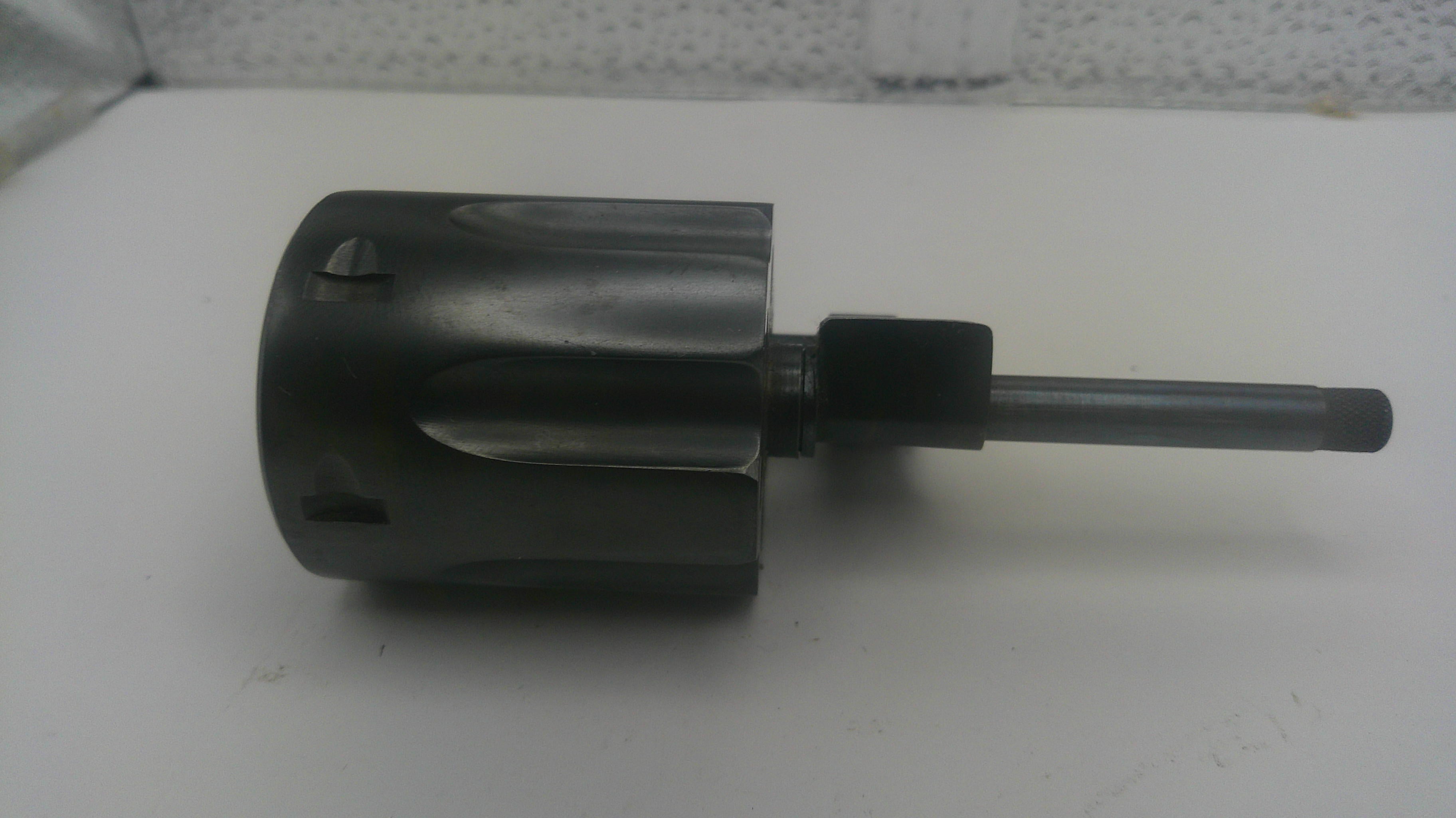 A dark gray metal rotary hammer drill bit with a long shank, photographed on a plain white surface.