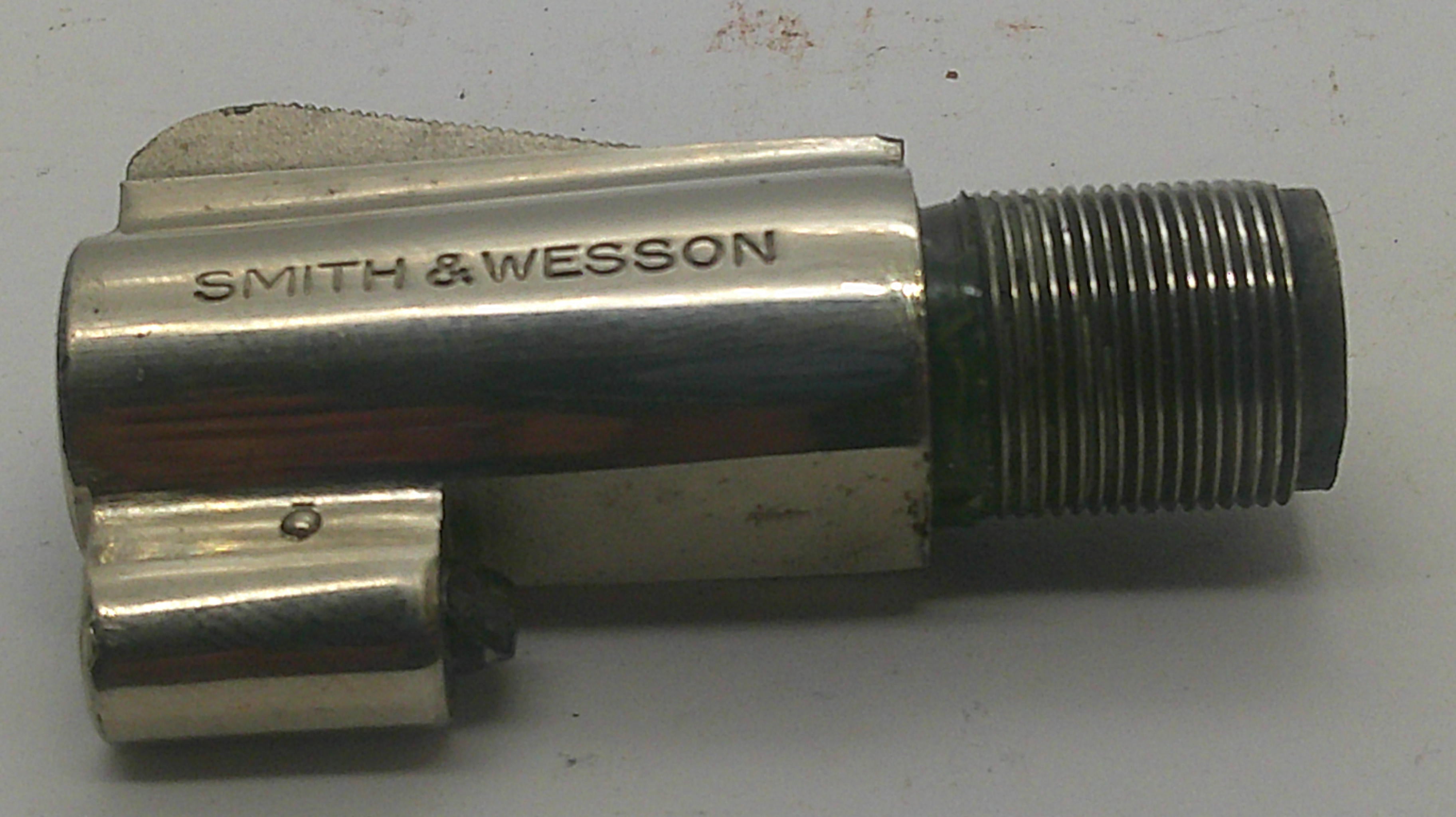A metallic Smith & Wesson faucet cartridge with a threaded connection, photographed on a plain light background.