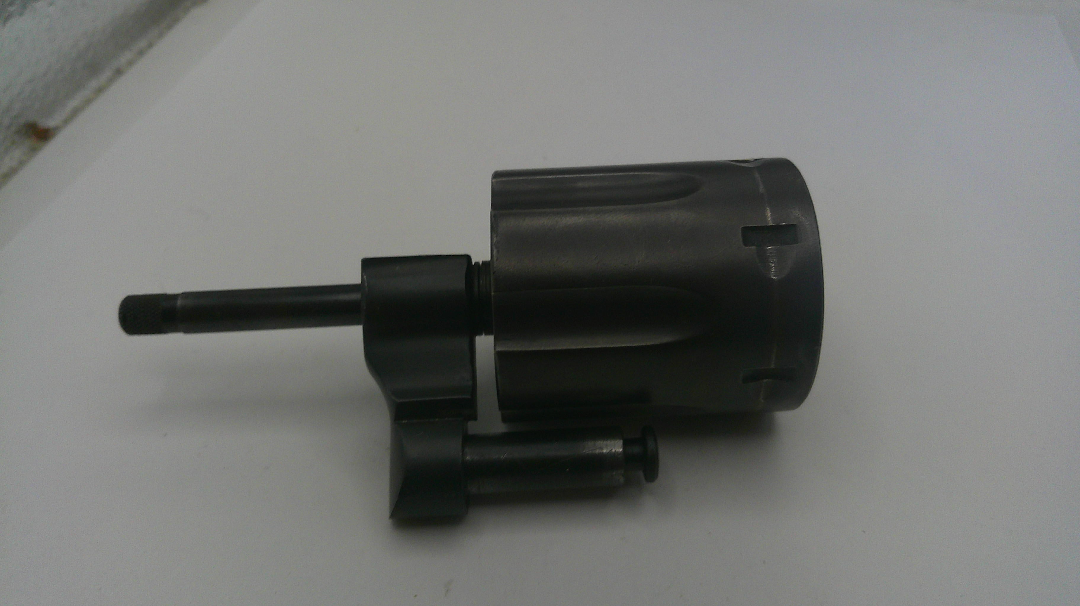 Black cylindrical mechanical component on a white background