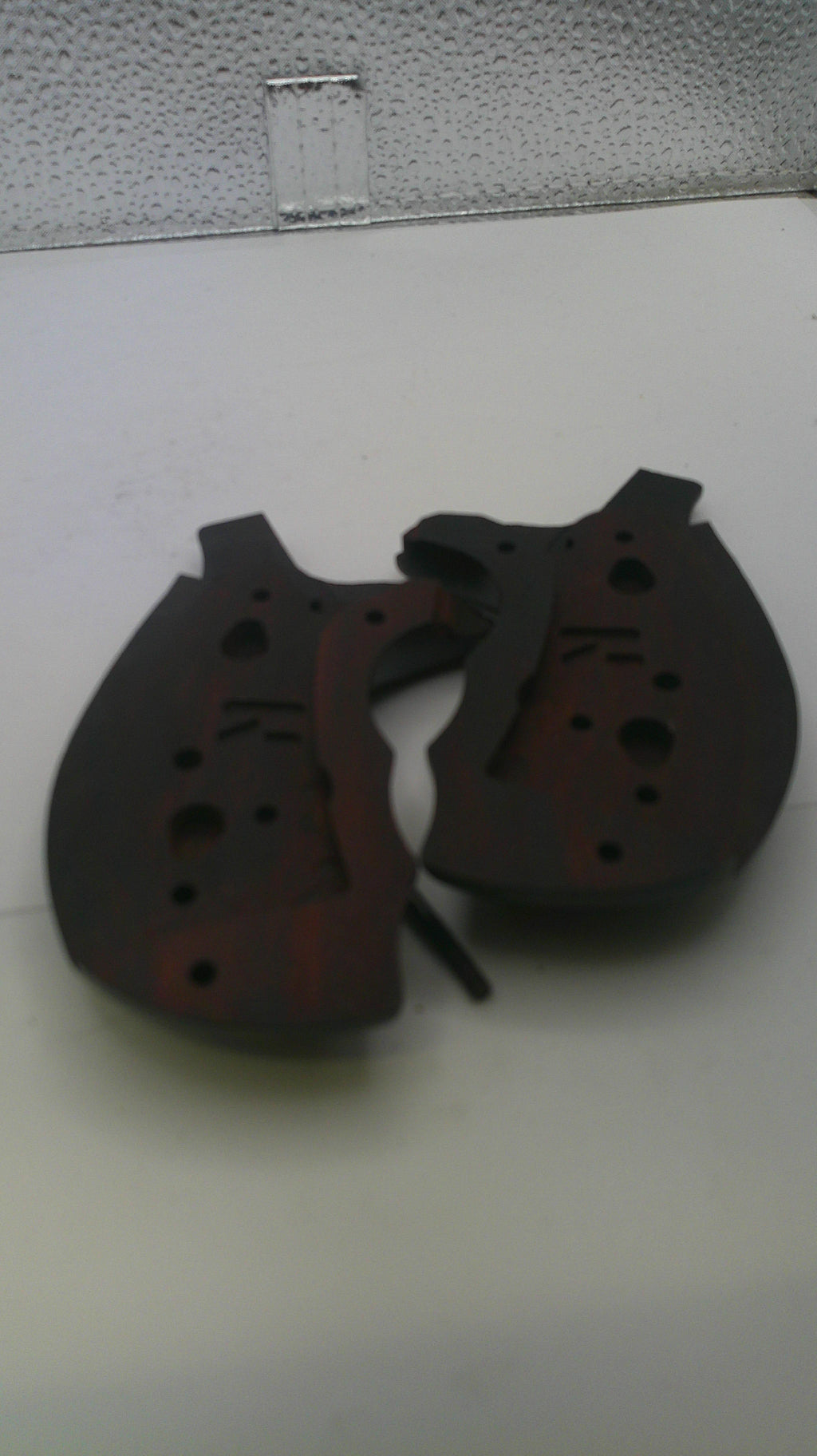 Black leather motorcycle gloves on a light gray surface