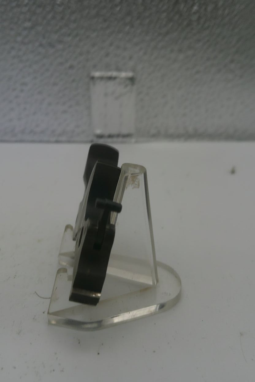 Small metal bracket on a textured wall