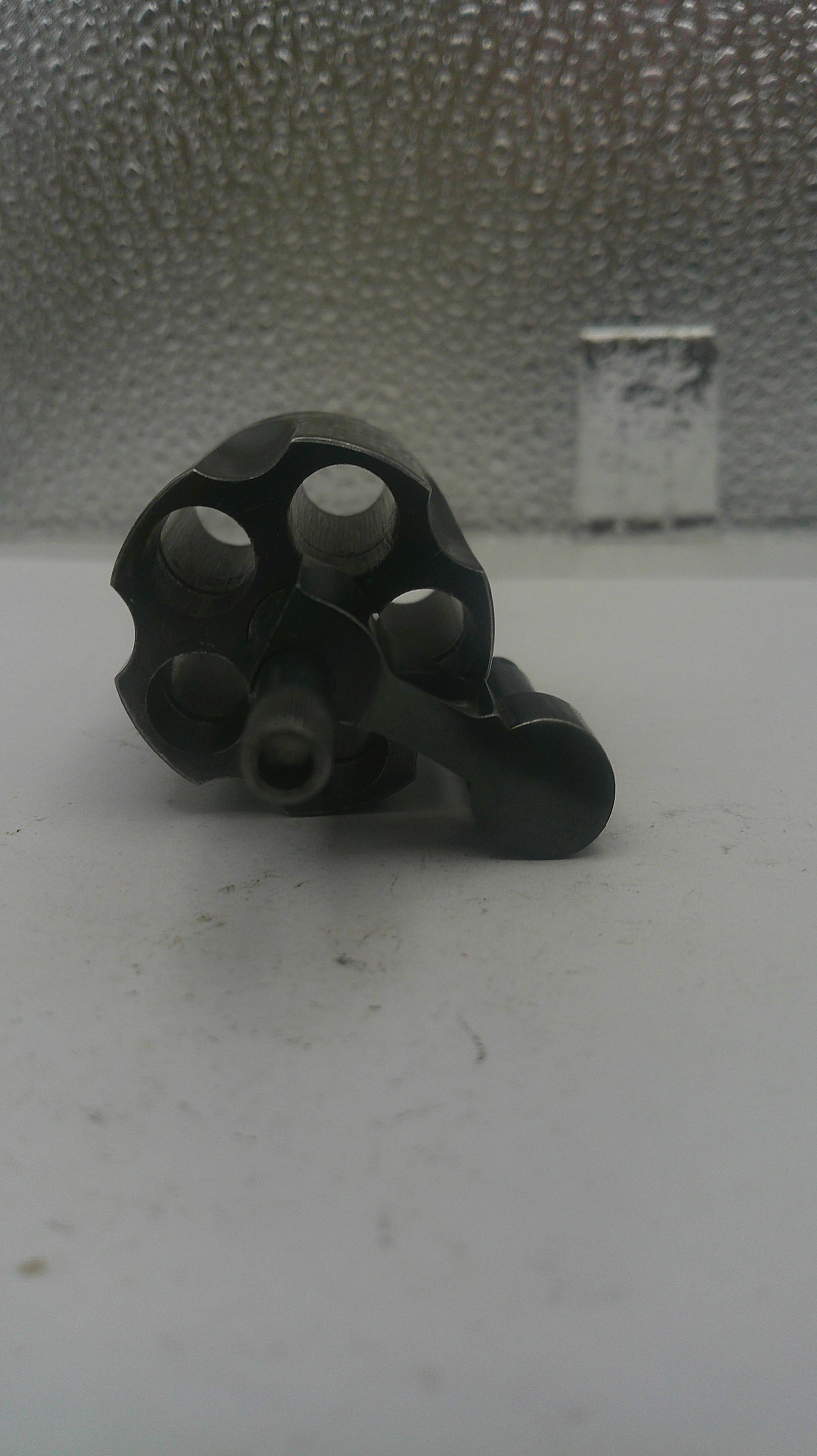 Black metal component on a textured white surface