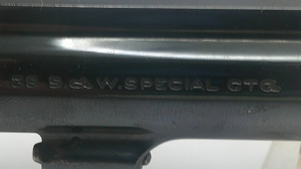 Close-up of a black metal firearm receiver with embossed text reading '56 S.G.W. SPECIAL CG6'.