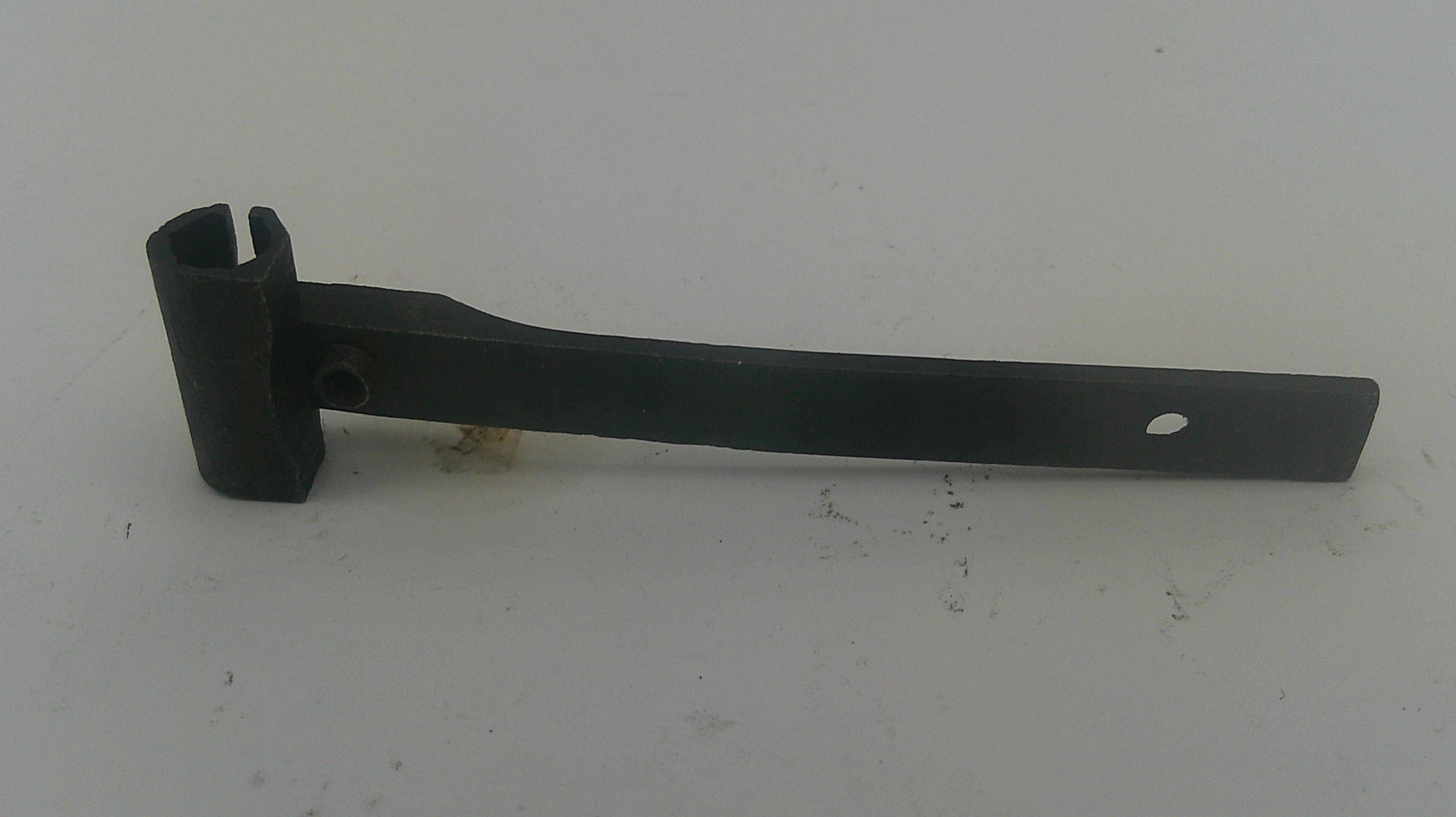 A black metal hinge or bracket with a long flat arm and a mounting clip, photographed on a plain light background.