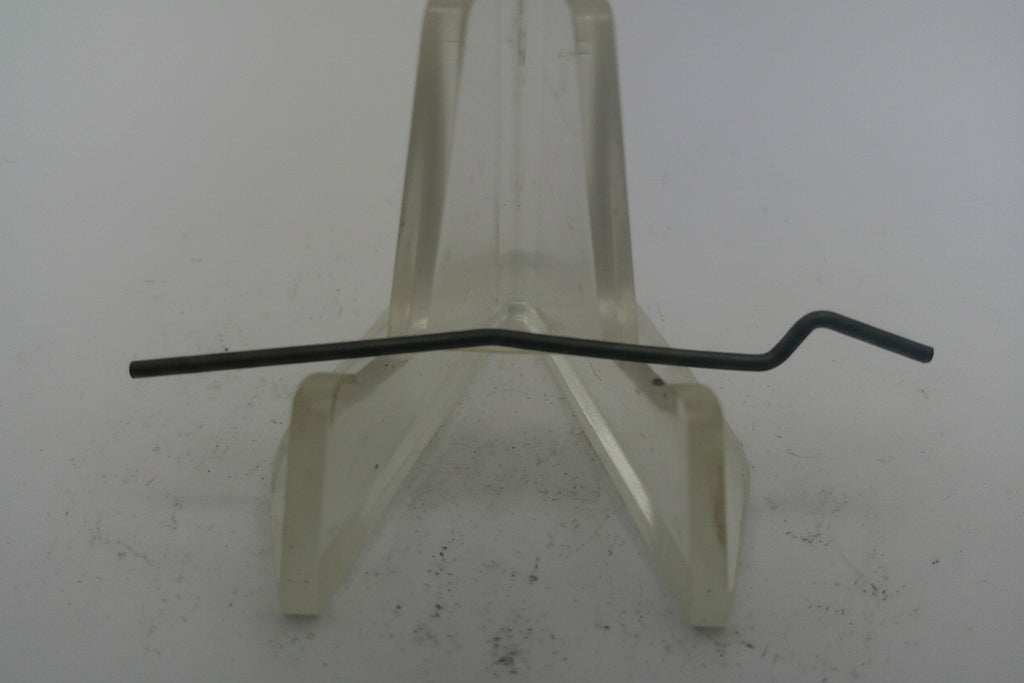 Metal rod on a white stand against a plain background