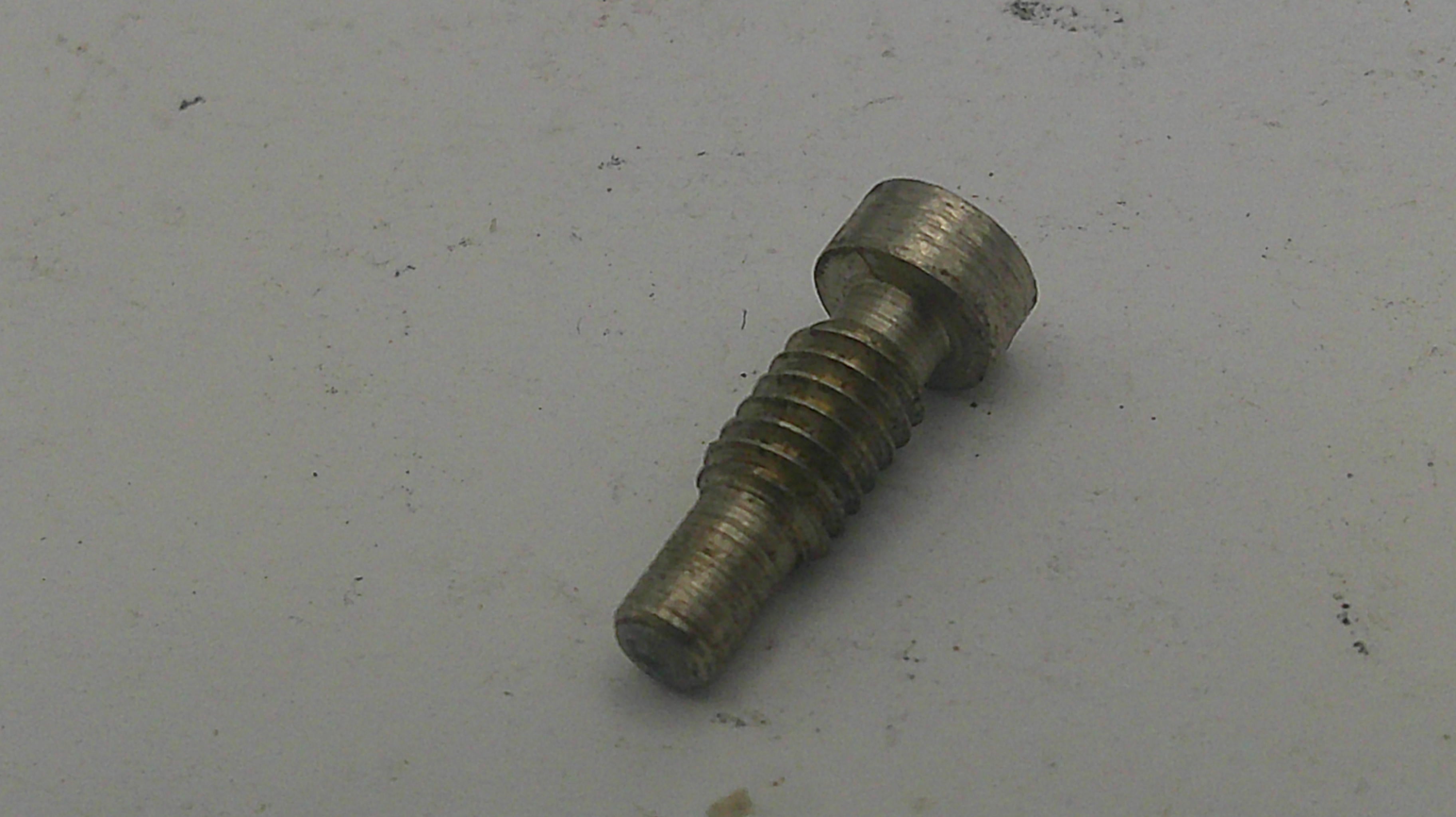 Metal screw on a gray background