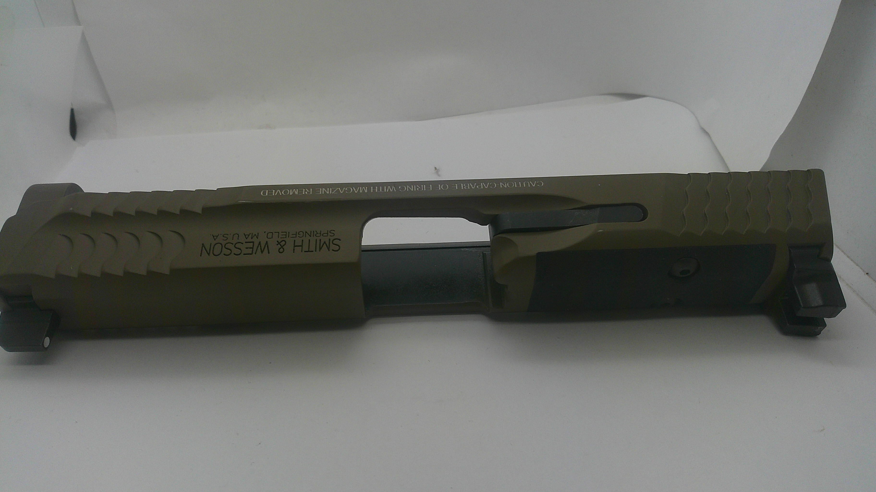 A Smith & Wesson slide component for a firearm, finished in olive green and black, photographed on a white background.
