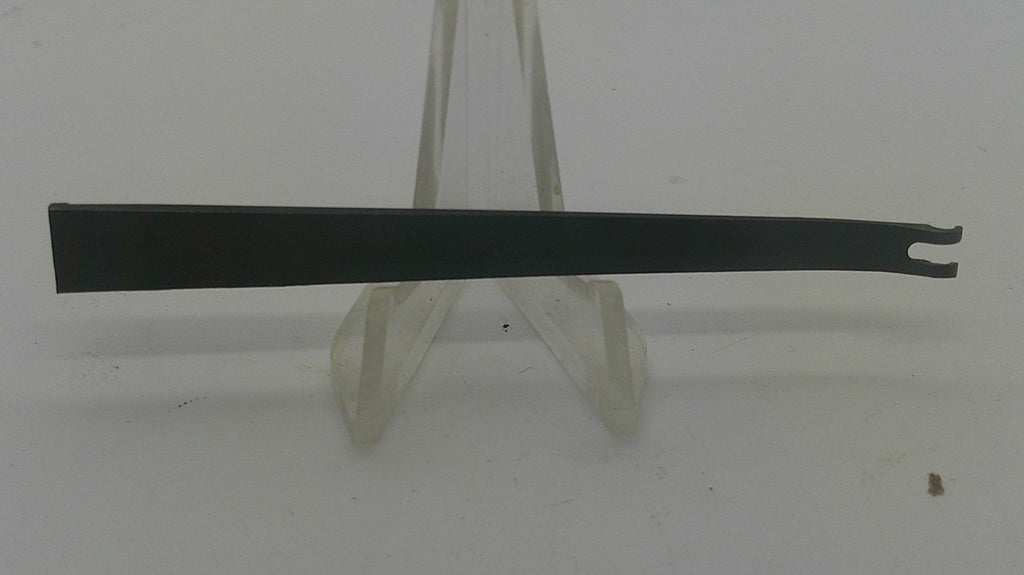 A flat black metal pry tool with a forked end, displayed horizontally on a clear plastic stand against a plain white background.