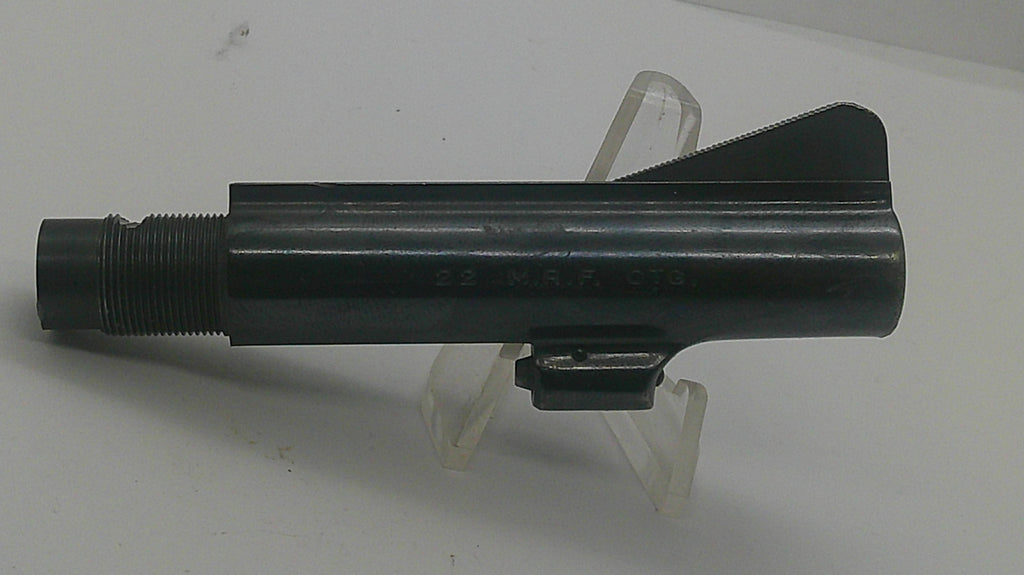 A black metal cylindrical tool or hardware component with a threaded end and a small angled tab, displayed on a clear plastic stand against a plain light background.