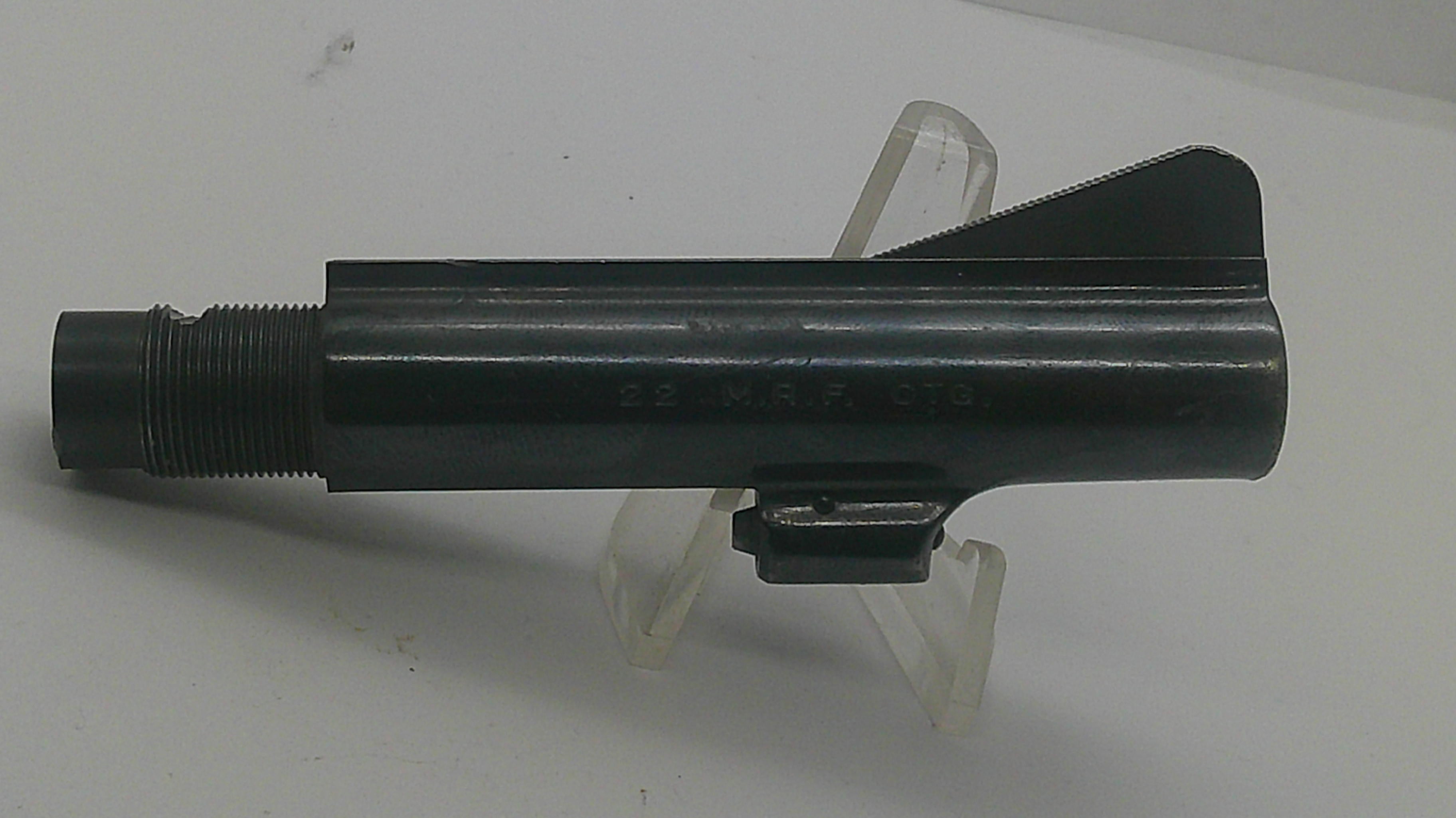 A black metal cylindrical tool or hardware component with a threaded end and a small angled tab, displayed on a clear plastic stand against a plain light background.