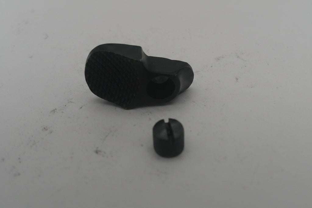 Two black rubber grommets on a white surface