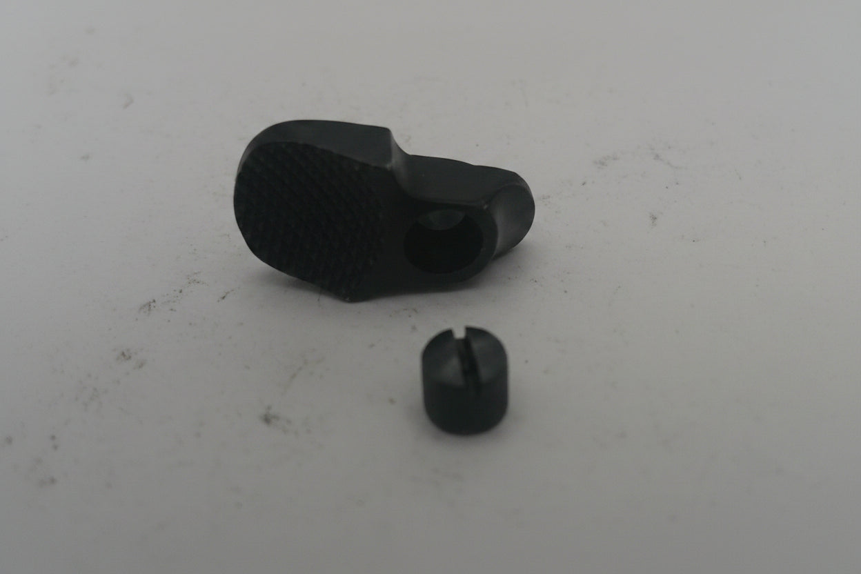 Two black rubber grommets on a white surface