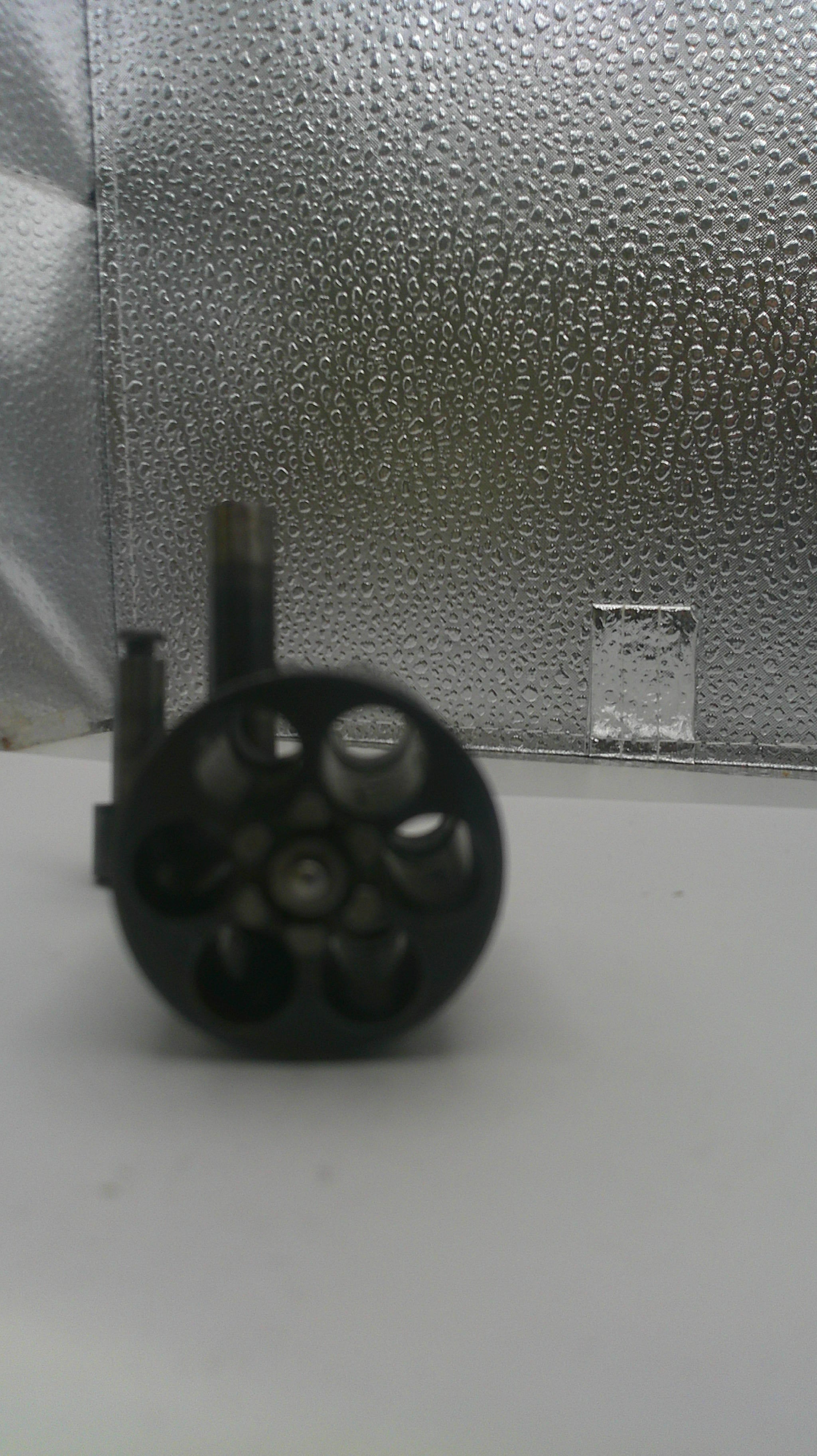 Black cylindrical object on a textured gray surface
