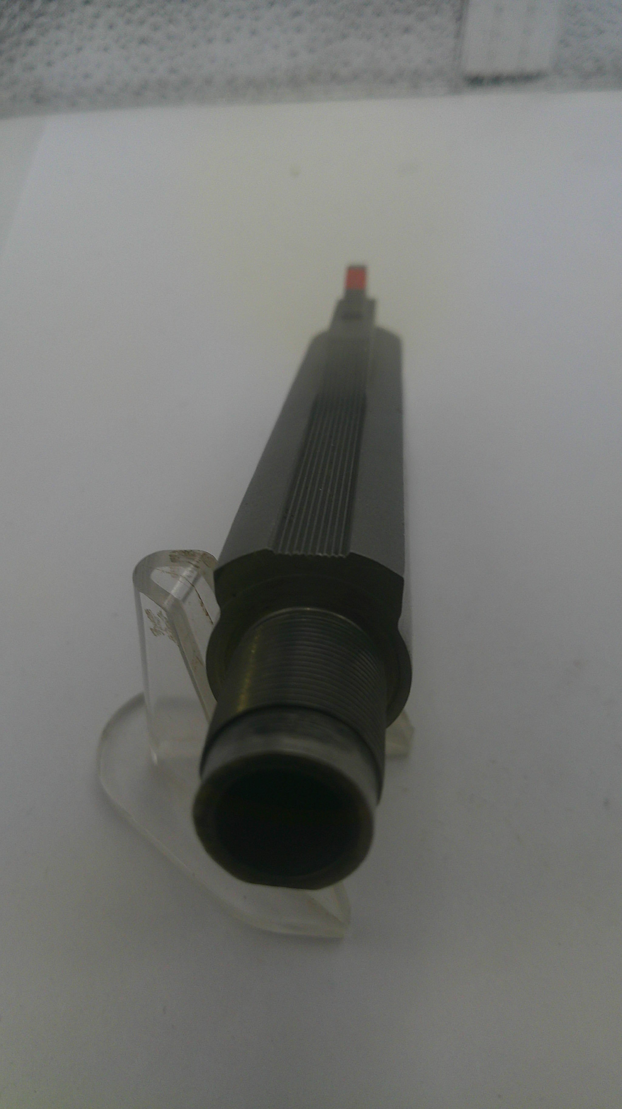 Black and gray cylindrical object on a white background
