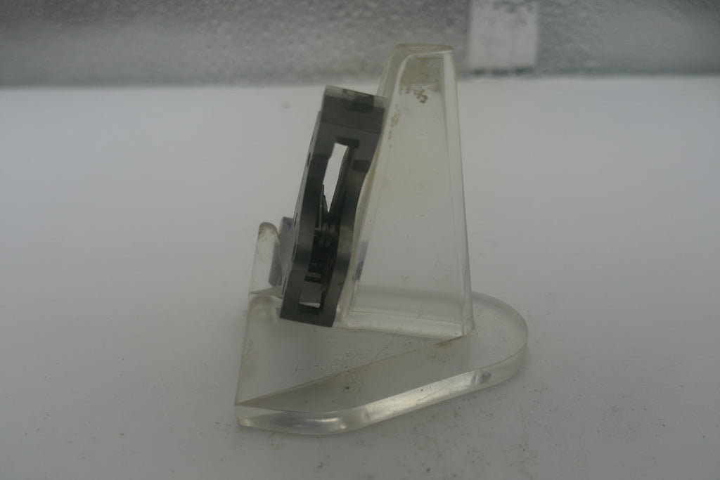 Metal bracket on a textured white surface