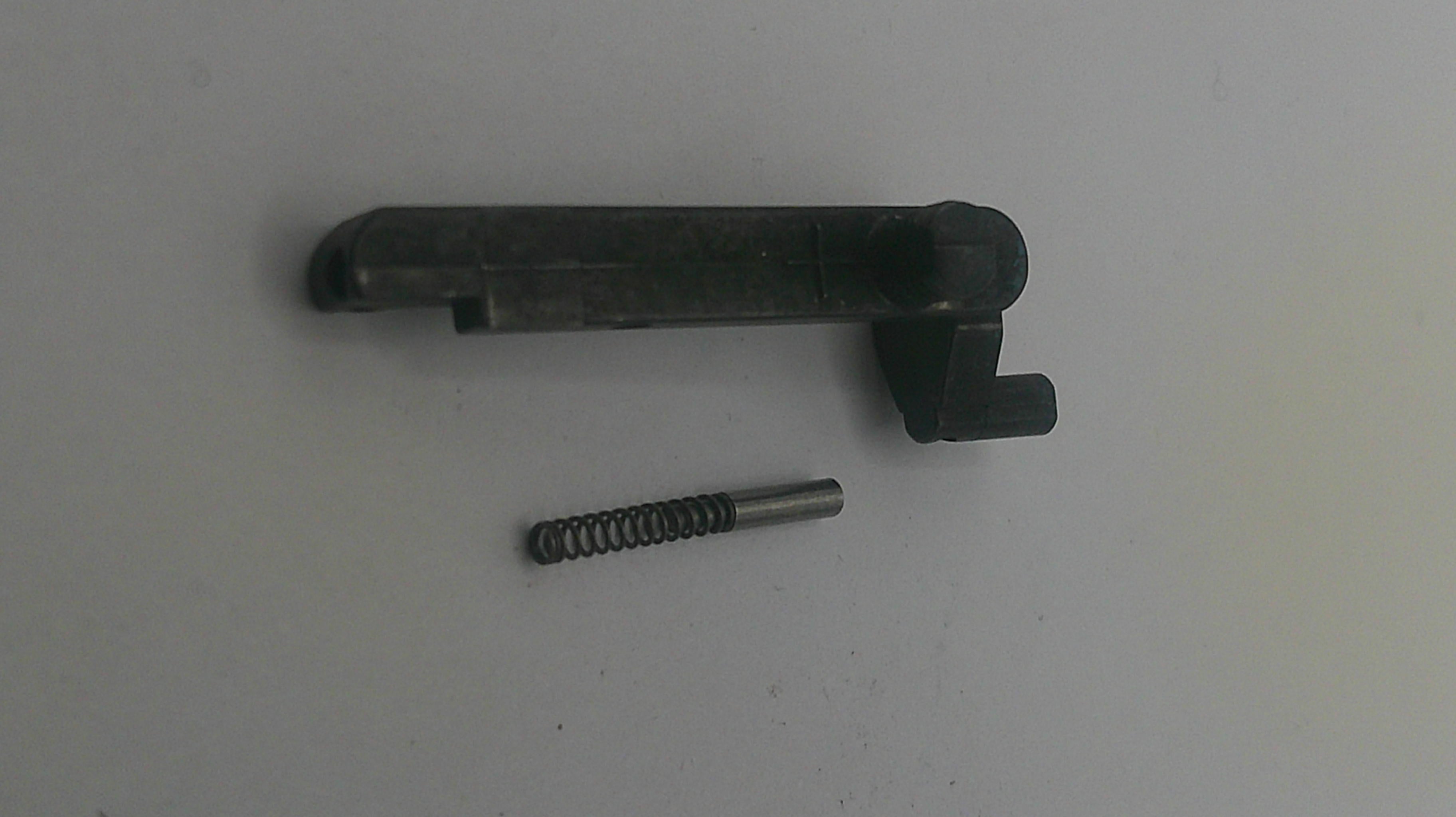 Black metal component and spring on a white background