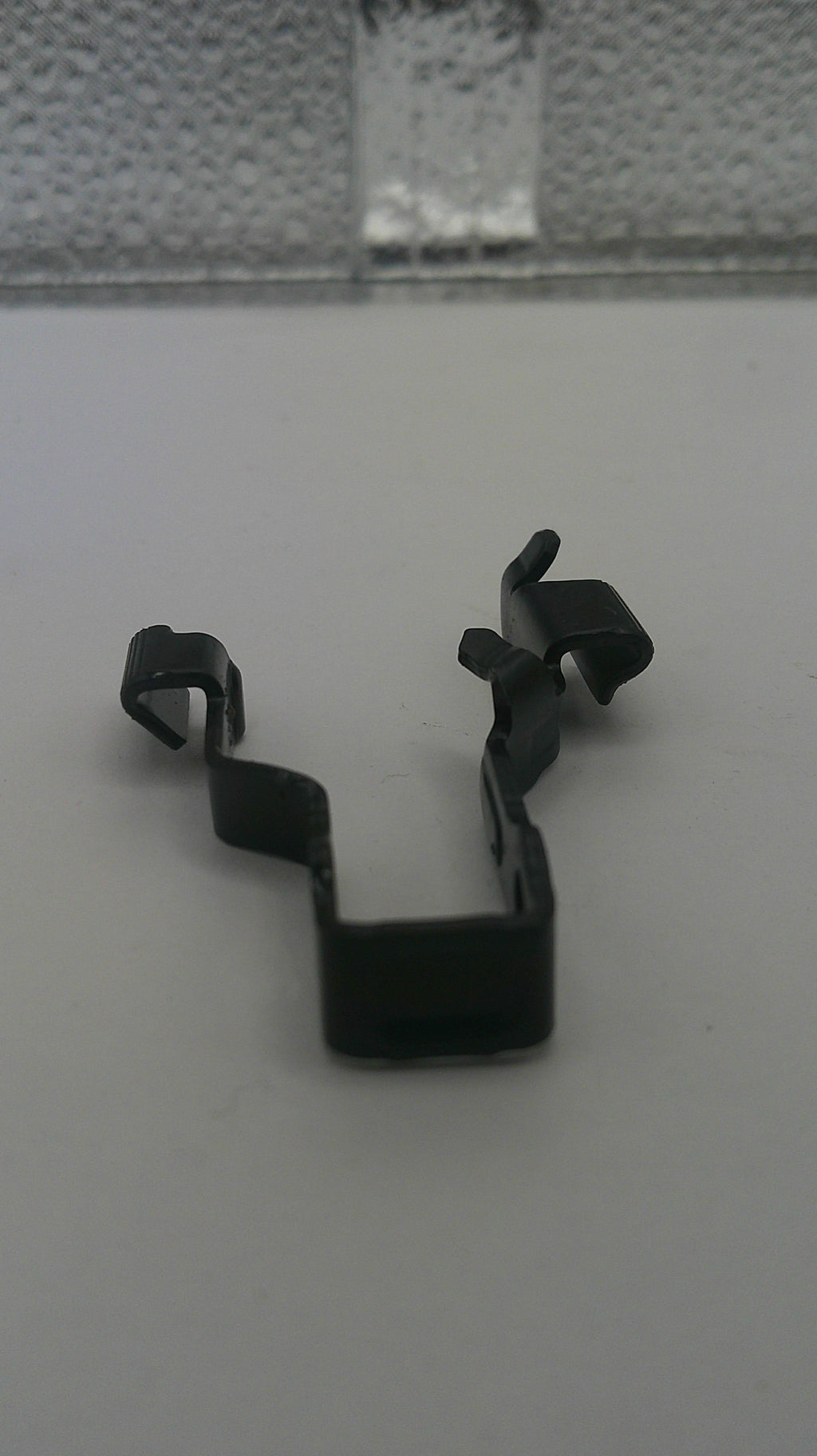 Black metal clip on a white background