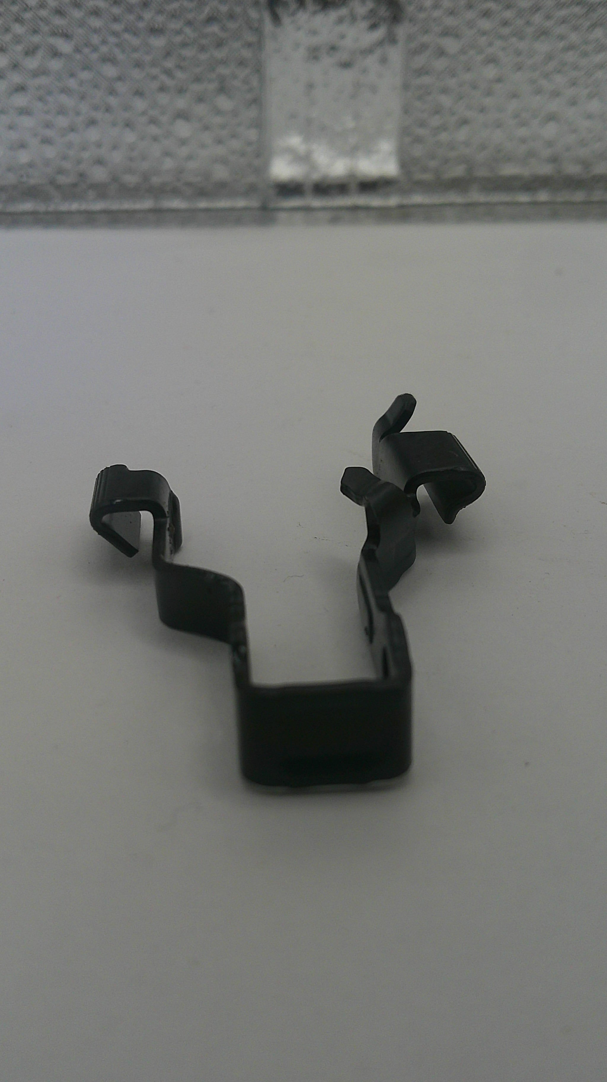 Black metal clip on a white background