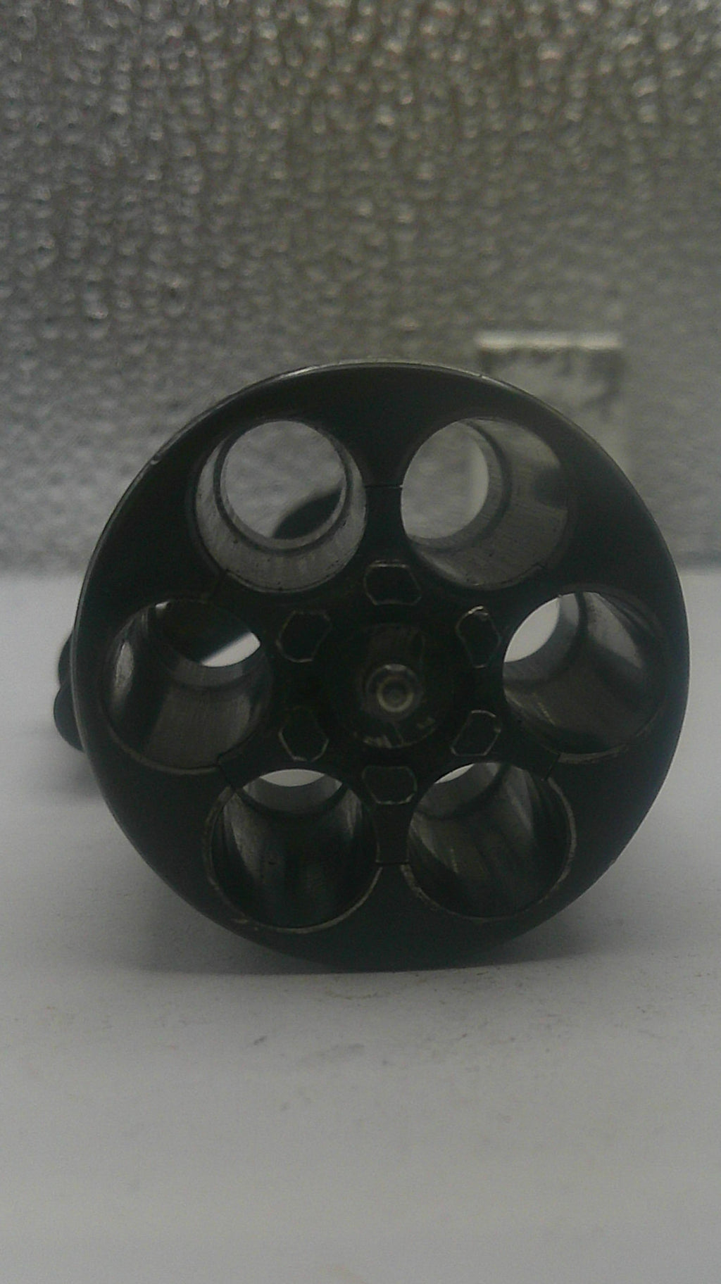Black metal knob on a textured surface