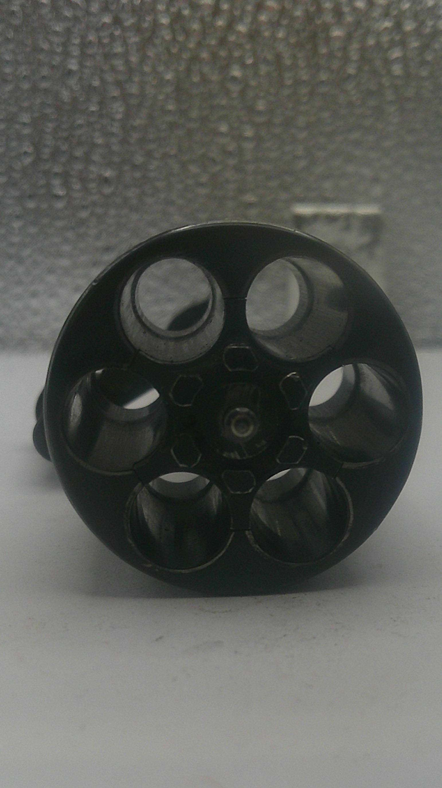 Black metal knob on a textured surface