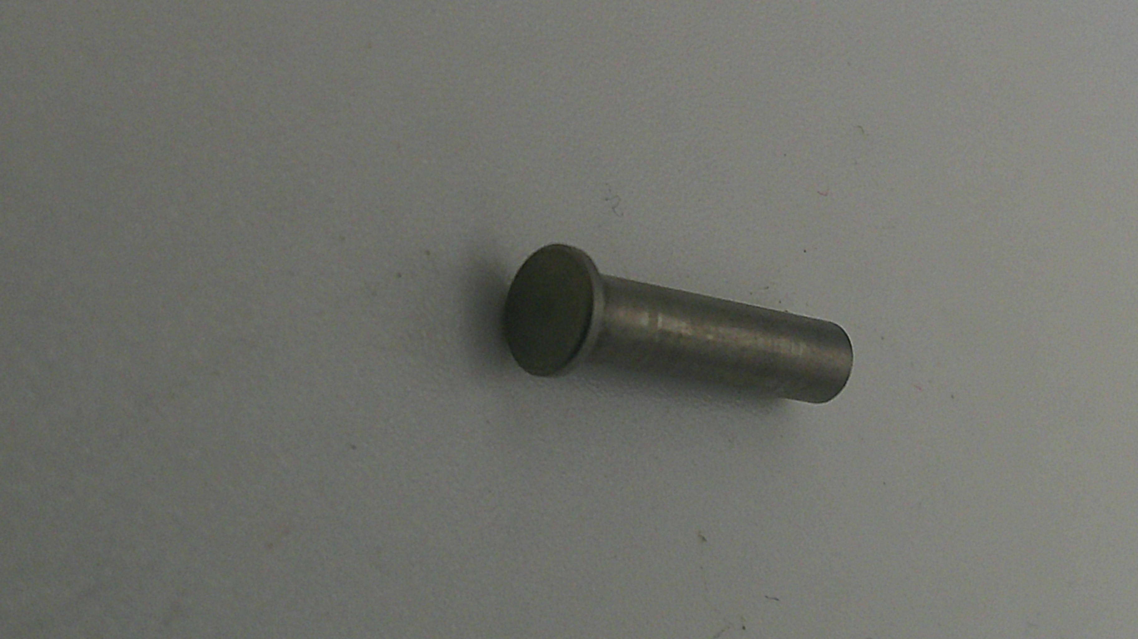 Metal cylindrical object on a gray background