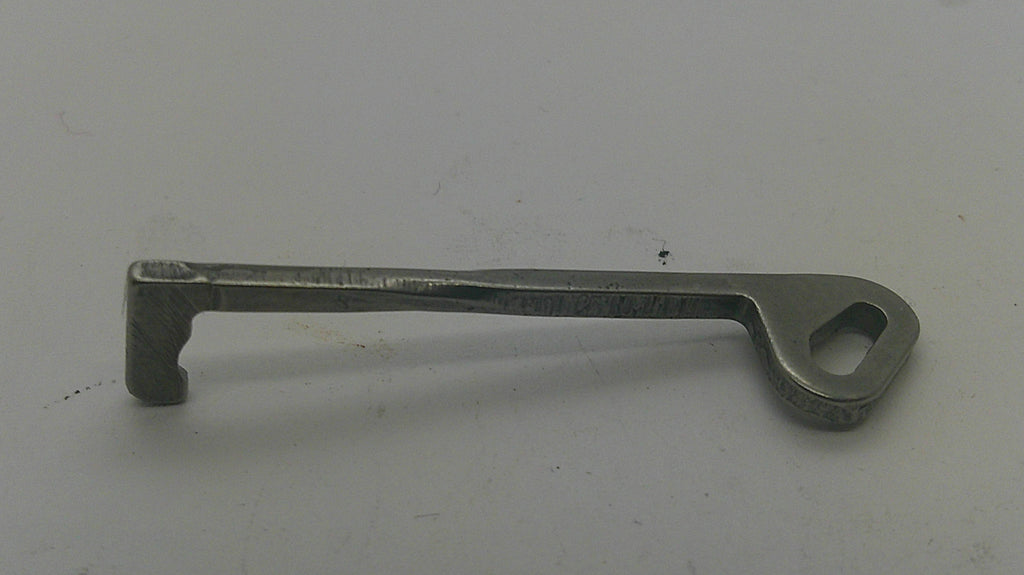 A small metal key-shaped tool with a looped end, photographed on a plain light background.