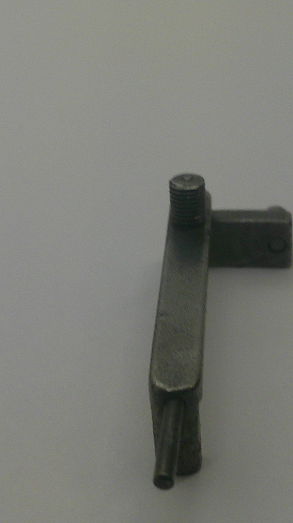 A small dark metal hardware piece with a flat rectangular bar, a threaded rod end, and a vertical mounting tab, shown against a plain light background.