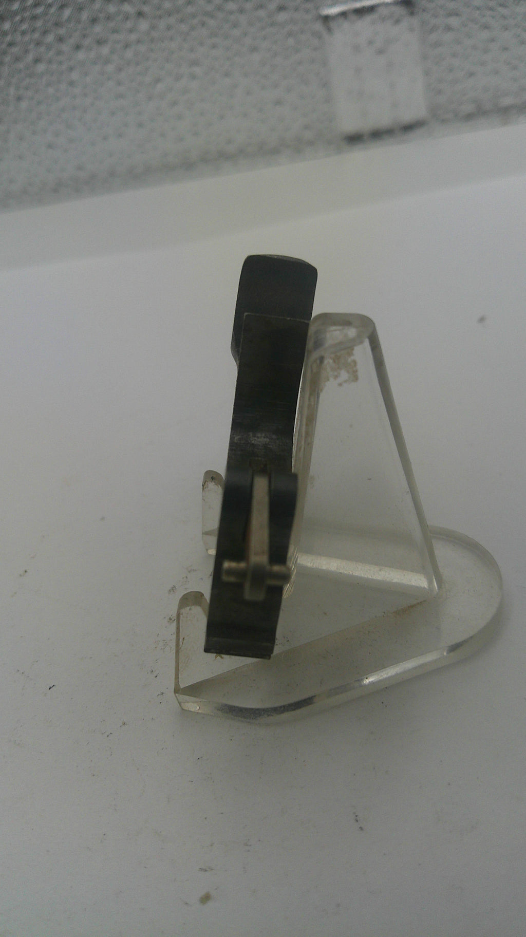 Close-up of a vinyl record needle on a white background