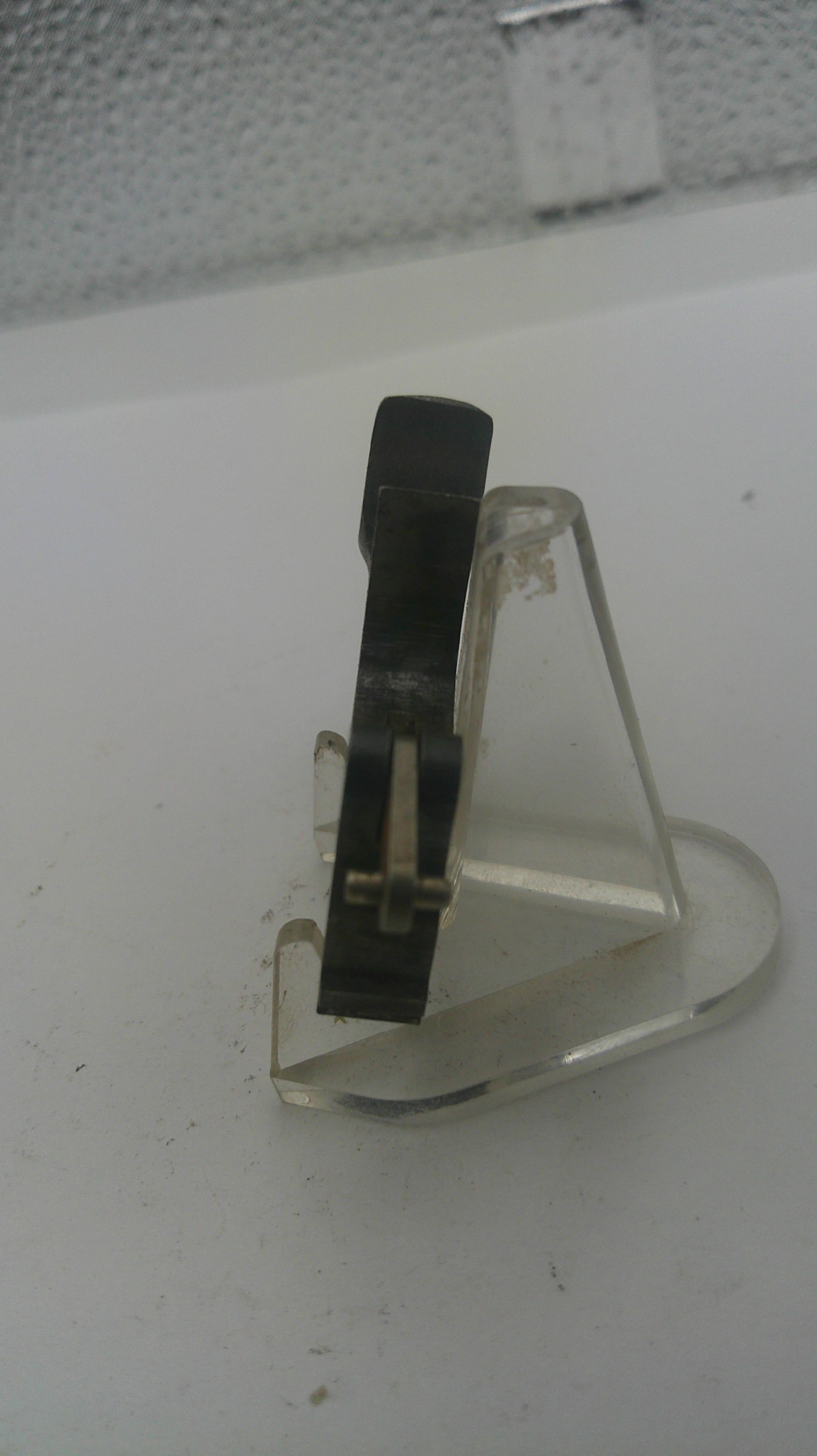 Close-up of a vinyl record needle on a white background