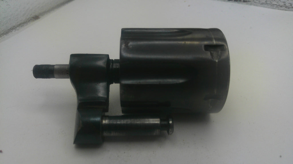 Black mechanical component on a white surface