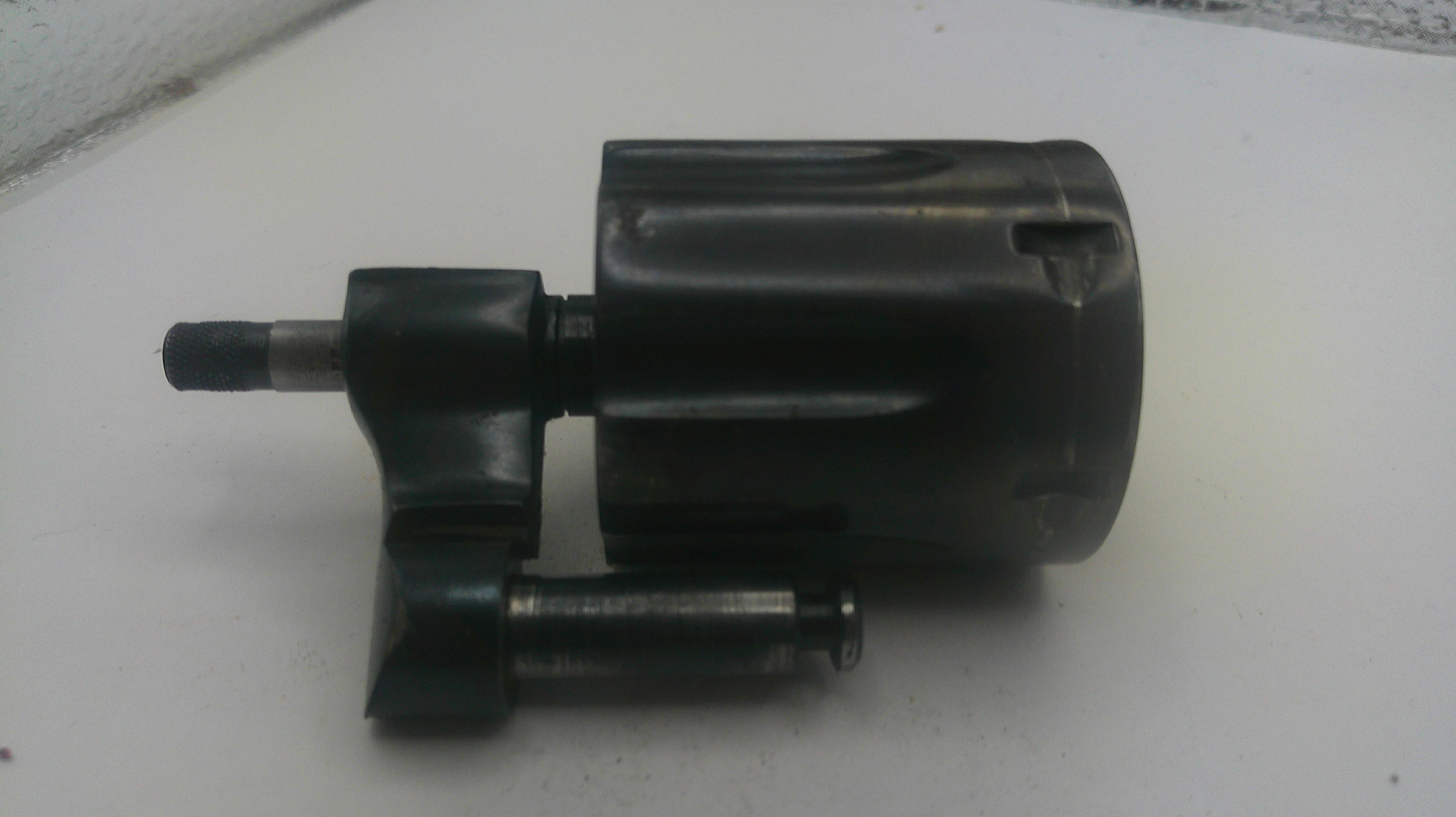 Black mechanical component on a white surface
