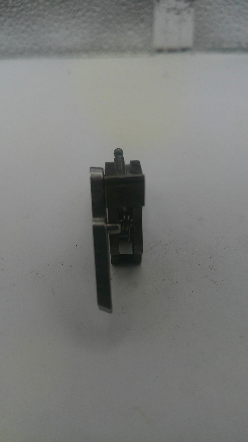 Small metal component on a white background