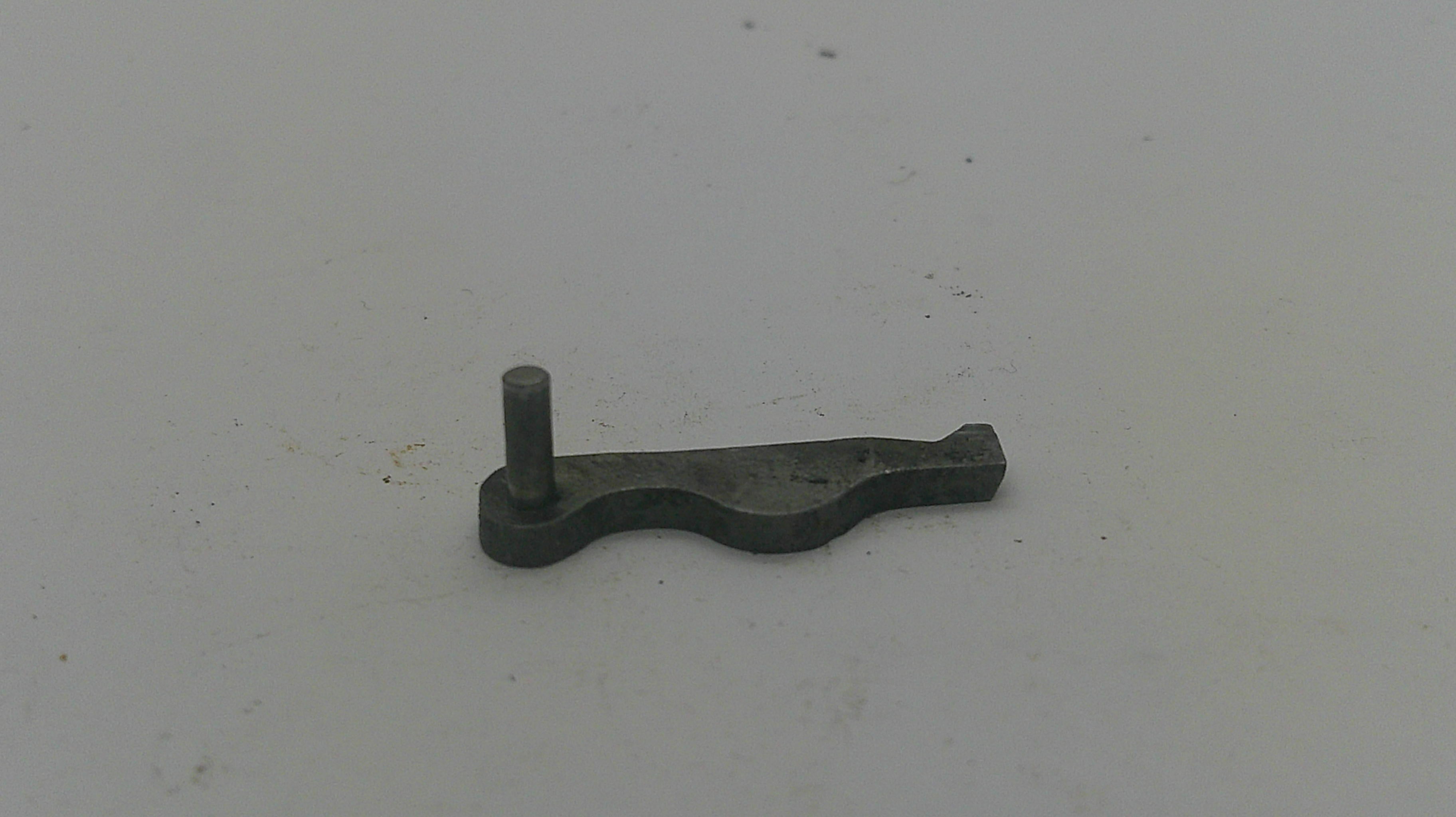 A small dark metal mechanical part with a bent stem, shown on a plain off-white background.