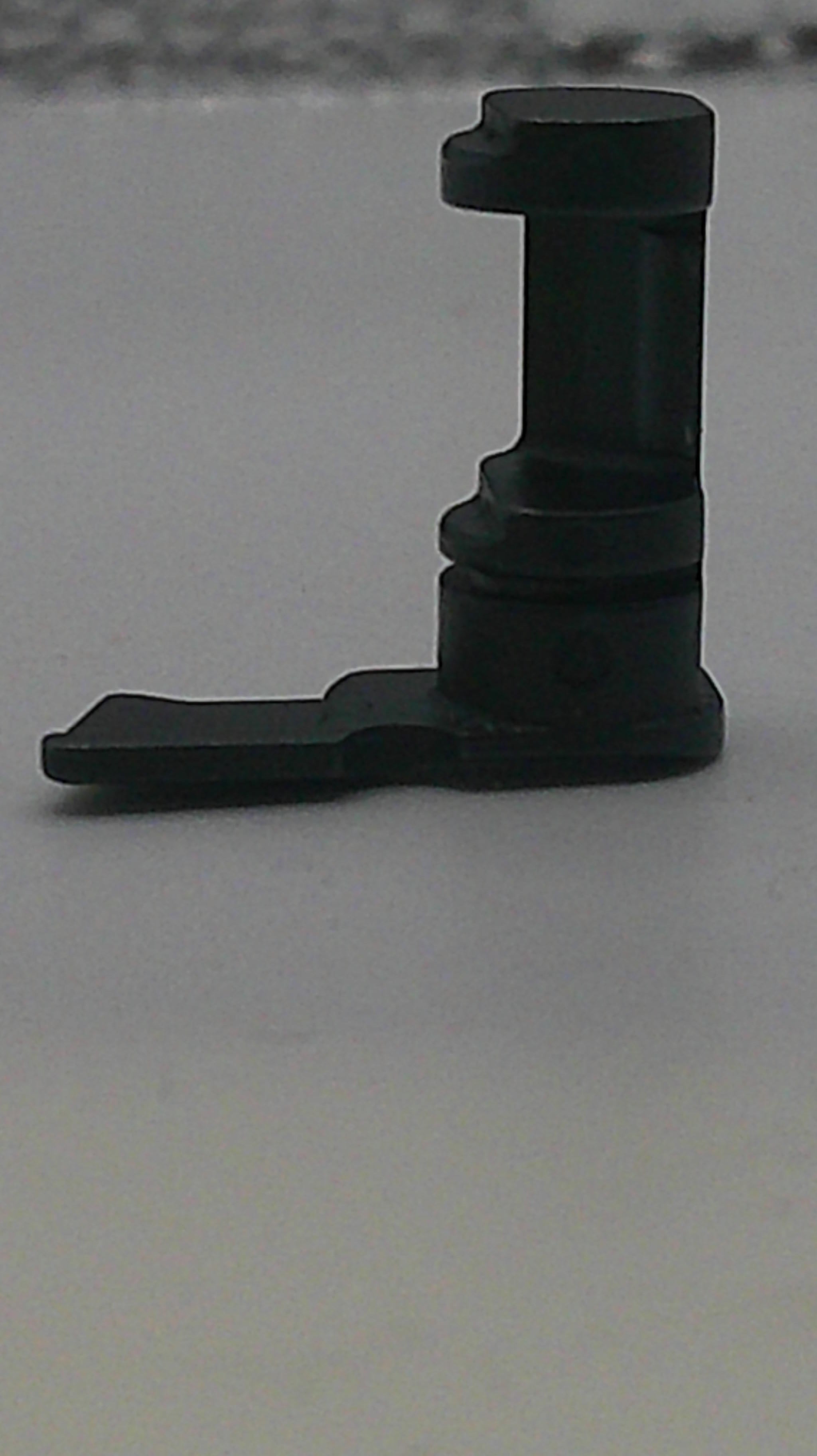 Black plastic L-shaped bracket on a light gray background
