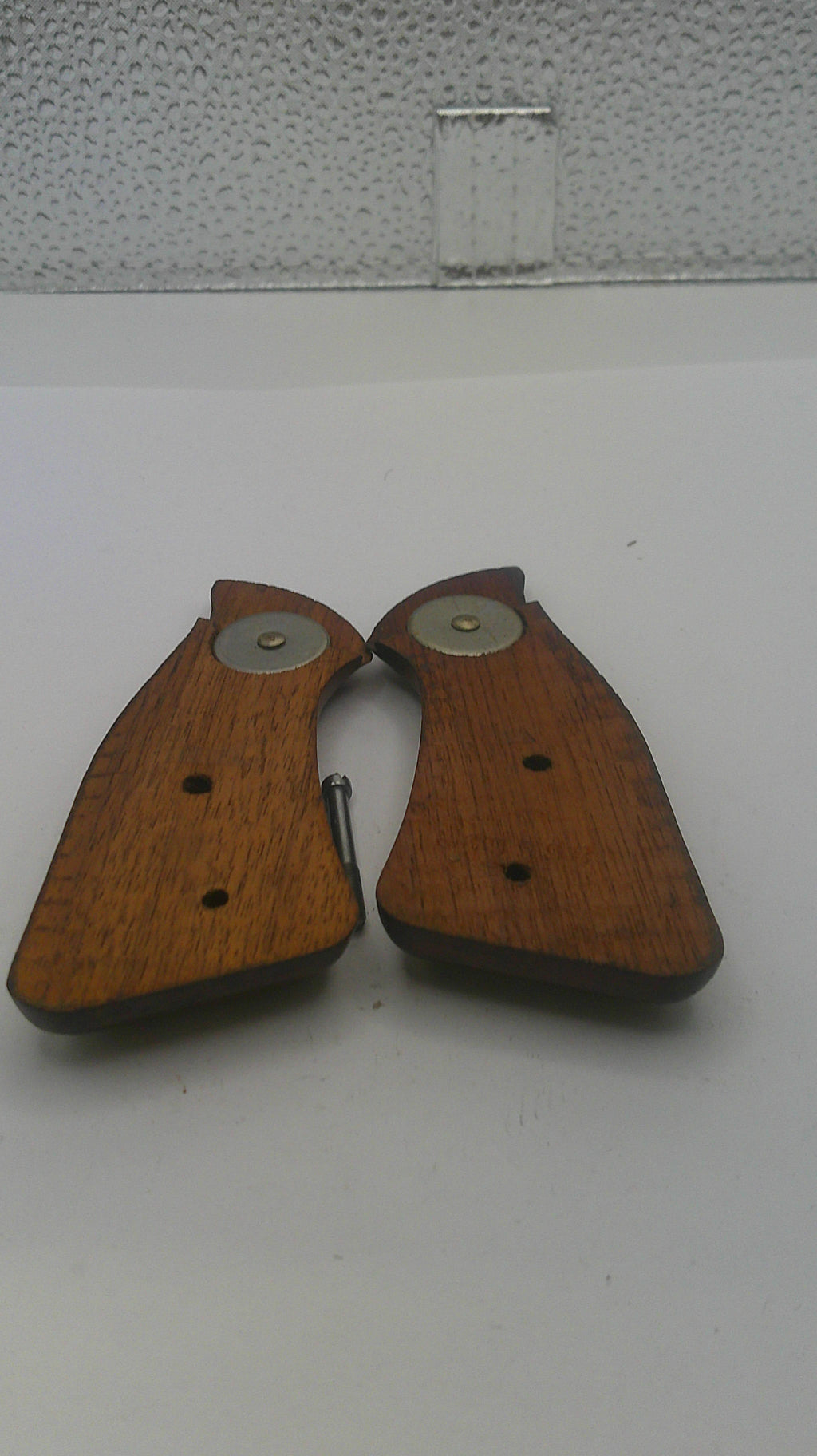 Pair of wooden gun grips on a white background