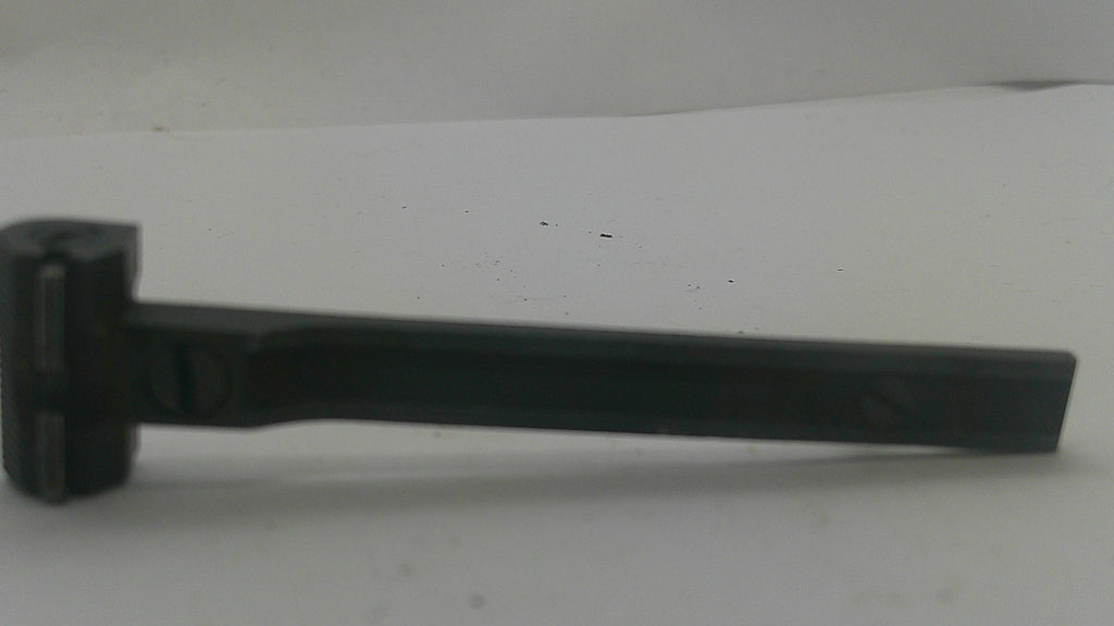 A black metal tool with a flat rectangular head and a long straight handle, photographed on a plain light background.