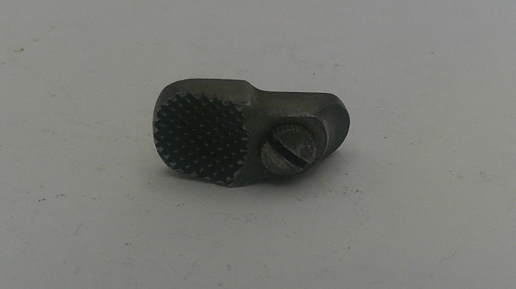 Metal tool with textured surface on a light gray background