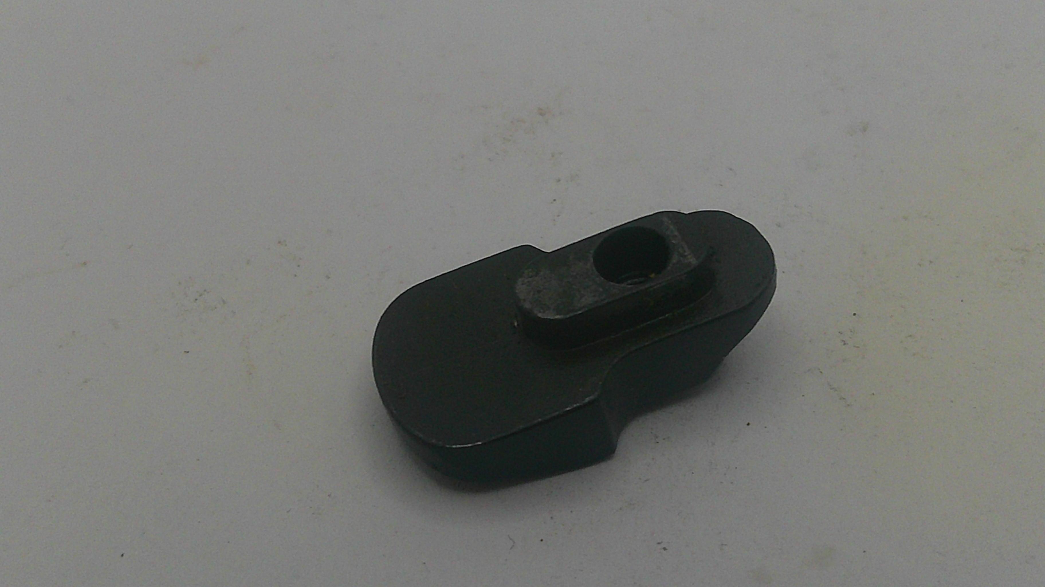 Black plastic component on a light gray background