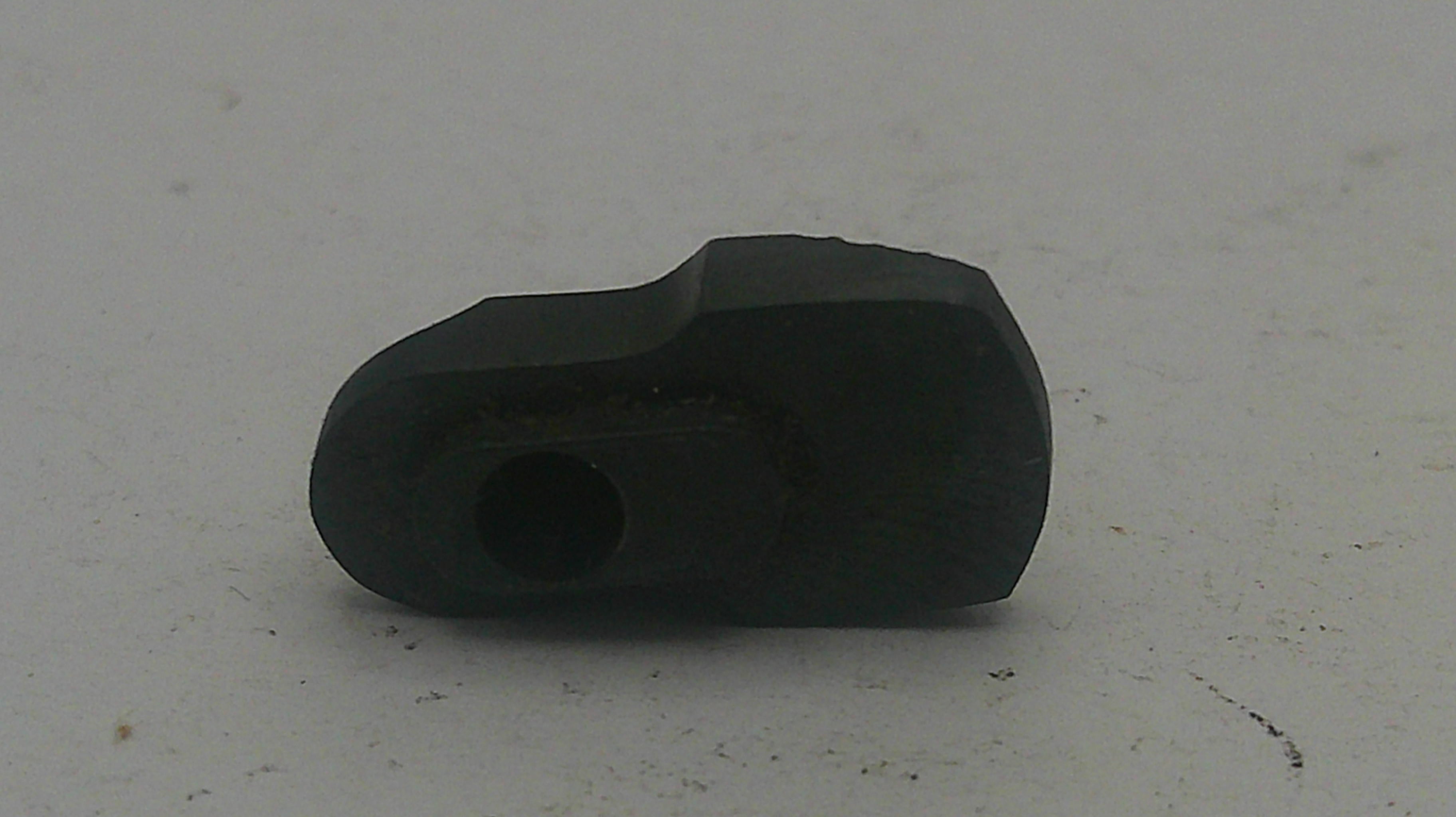 Black rubber grommet on a light gray background