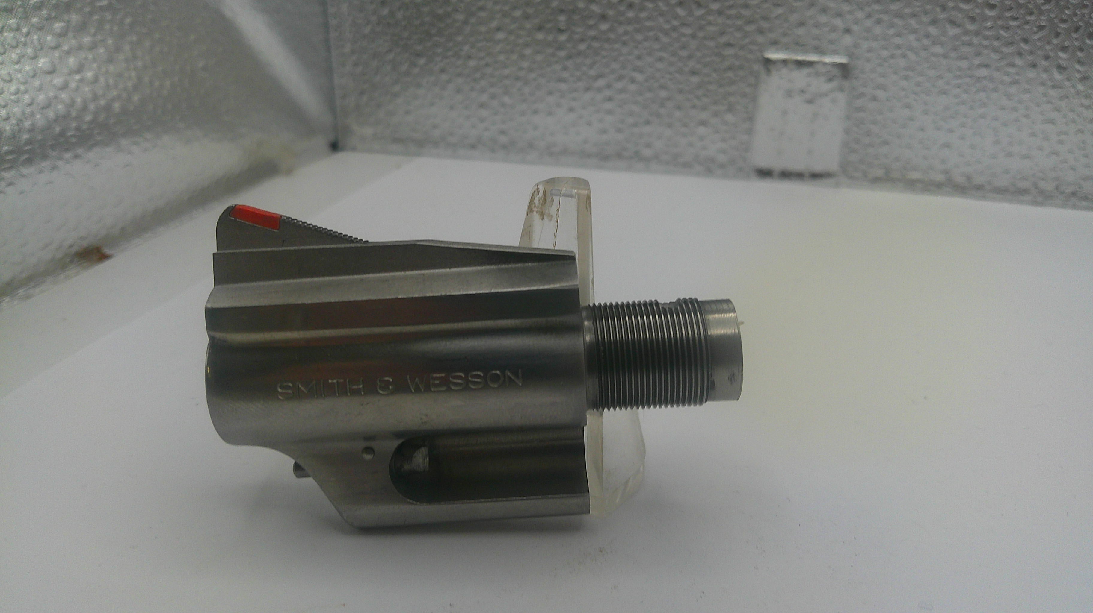 Metal mechanical component on a white surface with a textured background