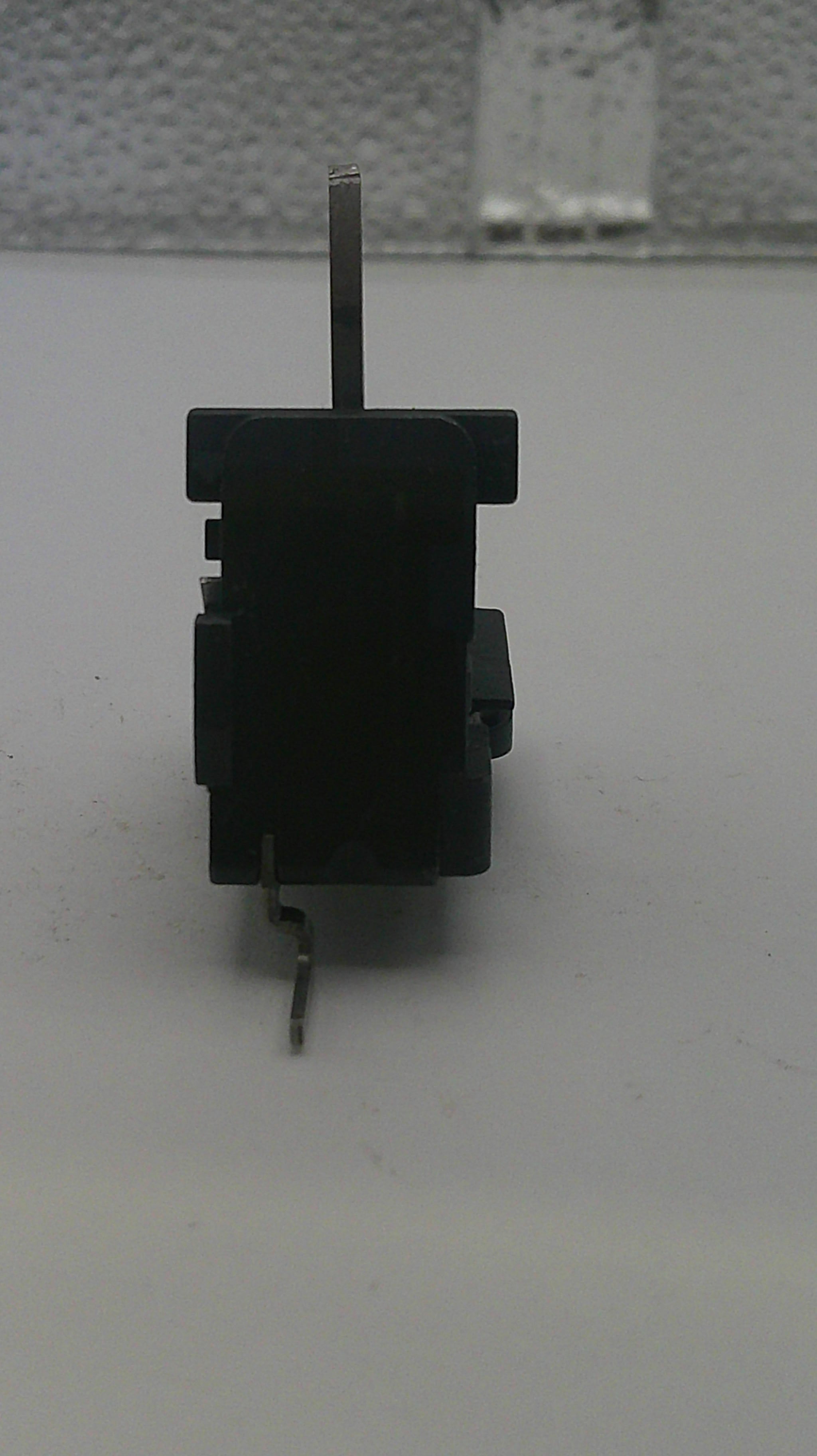 Small black mechanical component on a white background