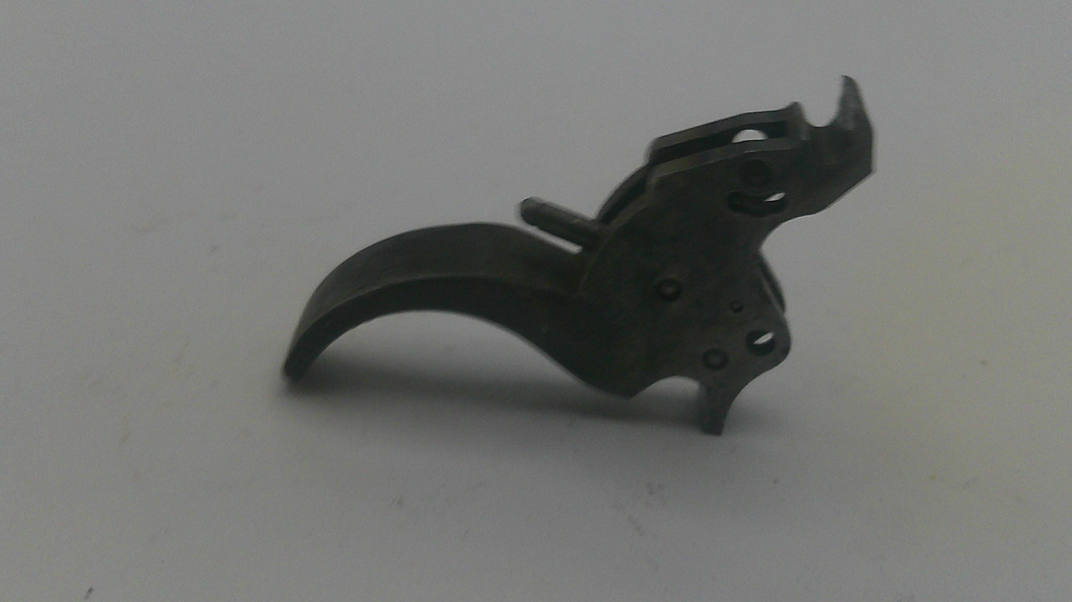 Black firearm trigger on a white background