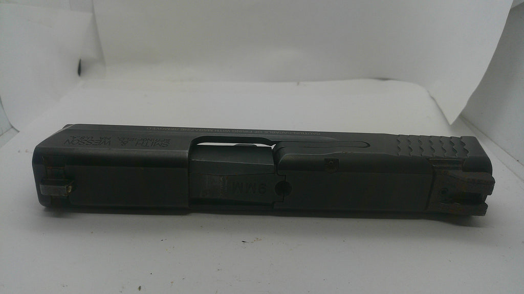 A black polymer Glock pistol grip and slide assembly, shown horizontally against a white background.