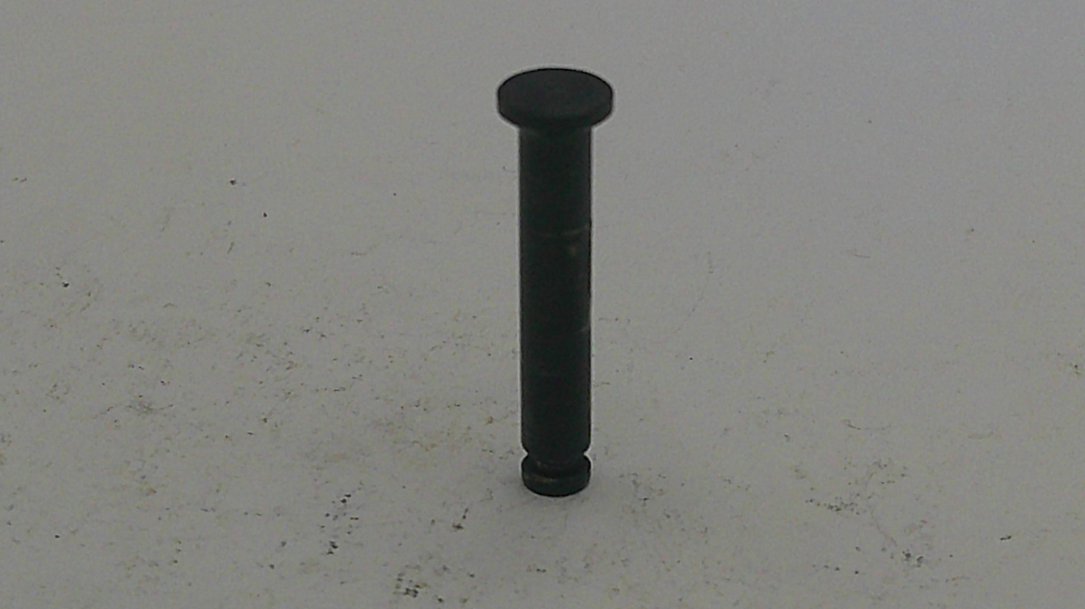 Black cylindrical object on a light gray background