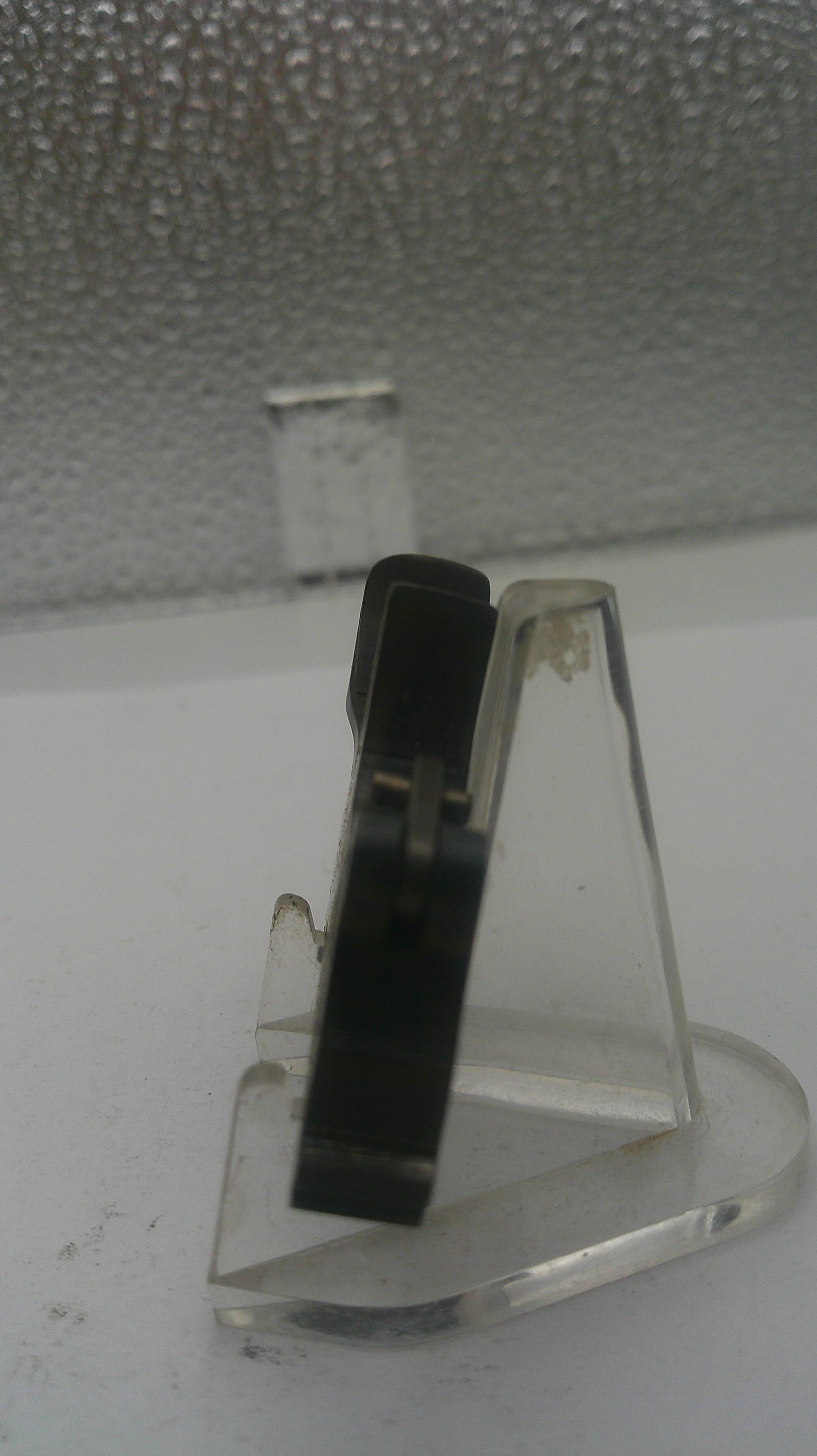 Clear plastic clip on a textured white surface