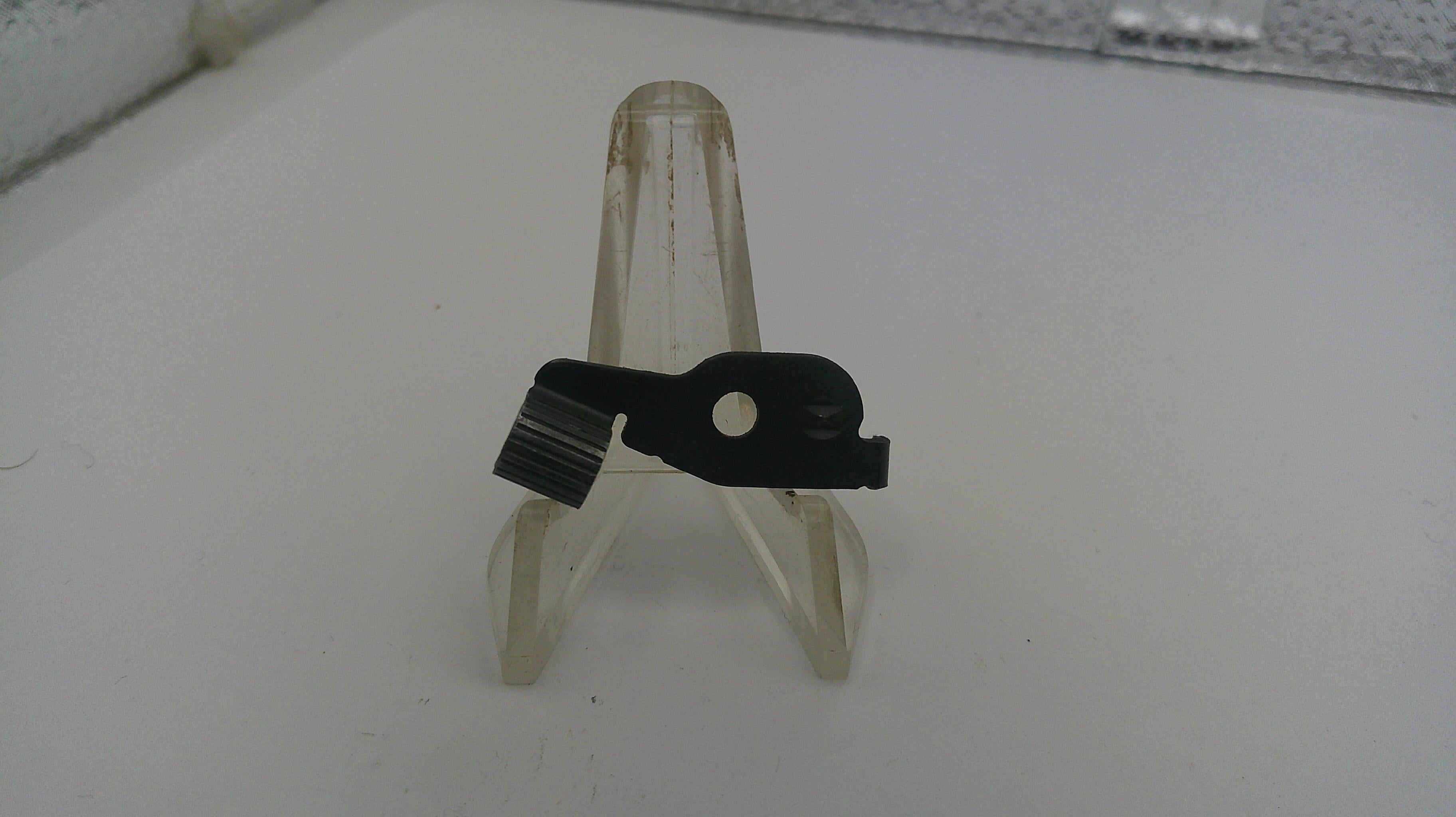 Small metal bracket on a white surface